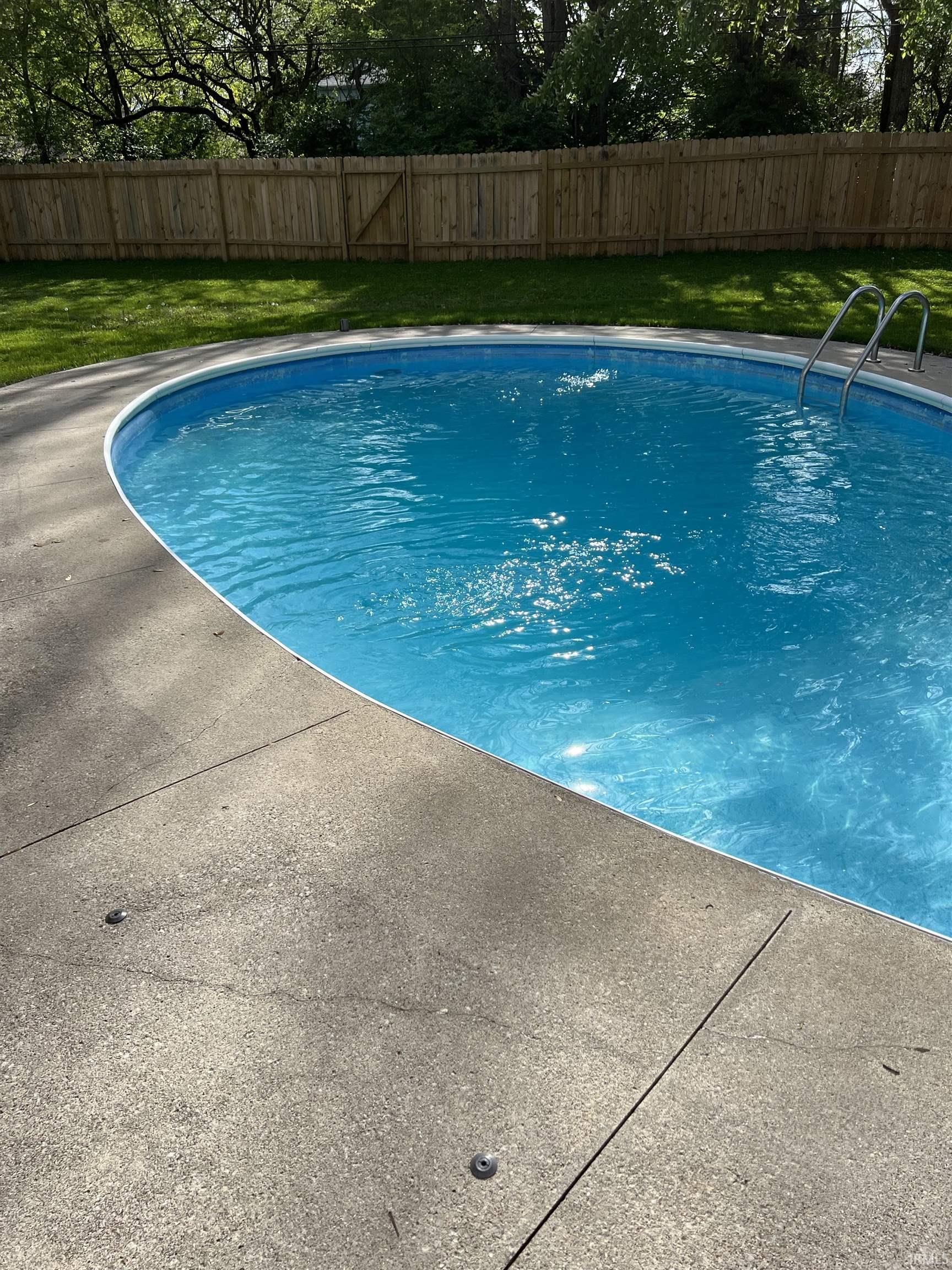 View of pool with a fenced backyard