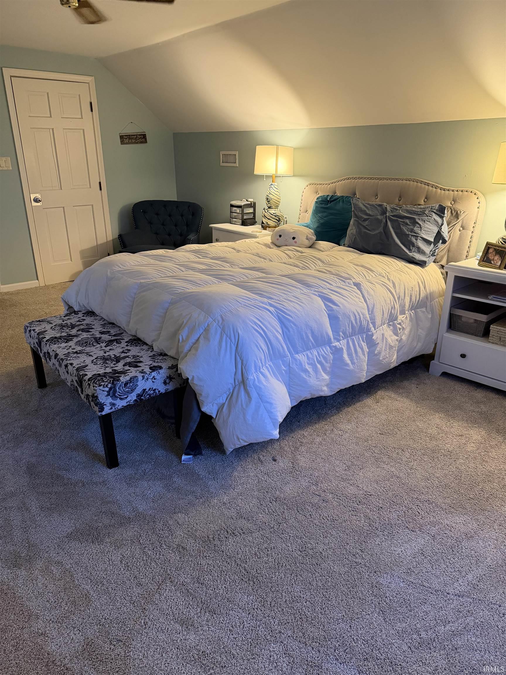 Carpeted bedroom with vaulted ceiling