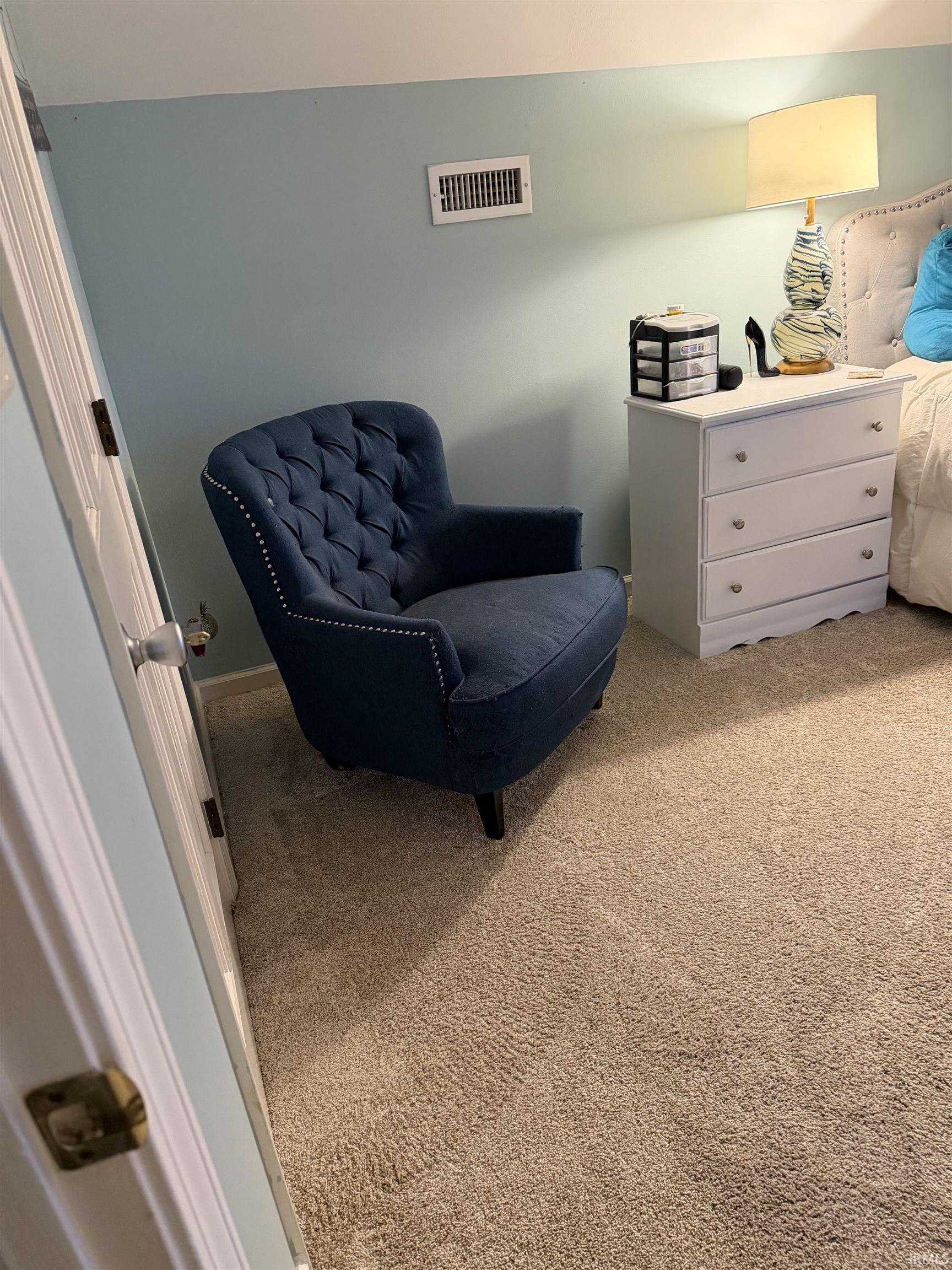 Sitting room featuring light colored carpet