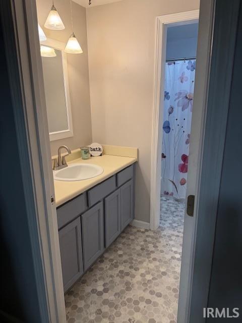 Bathroom with wallpapered walls and vanity