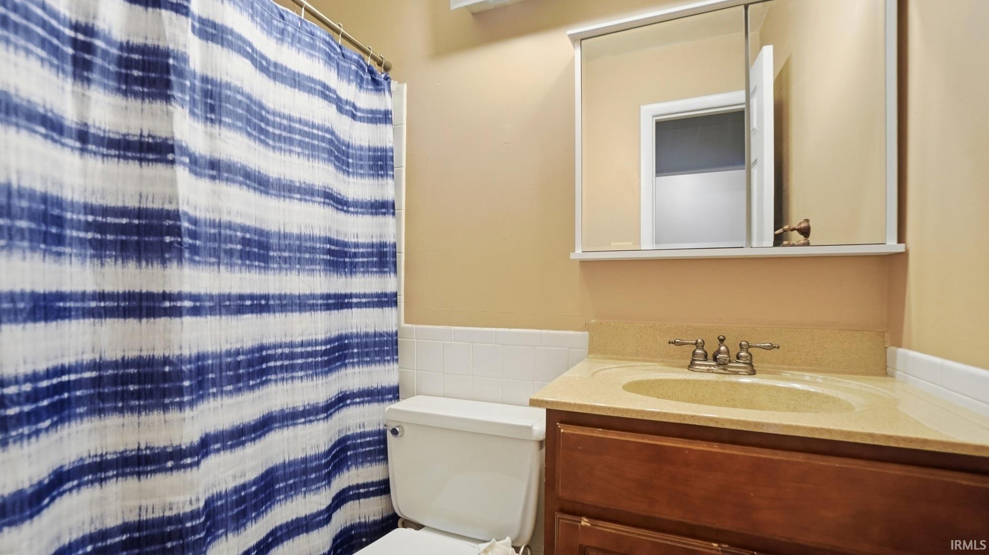 Full bathroom featuring vanity and curtained shower