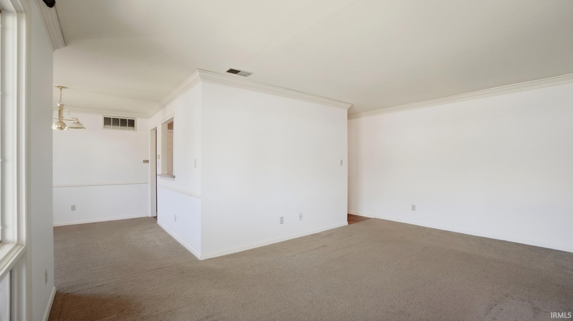 Unfurnished room with carpet floors and crown molding
