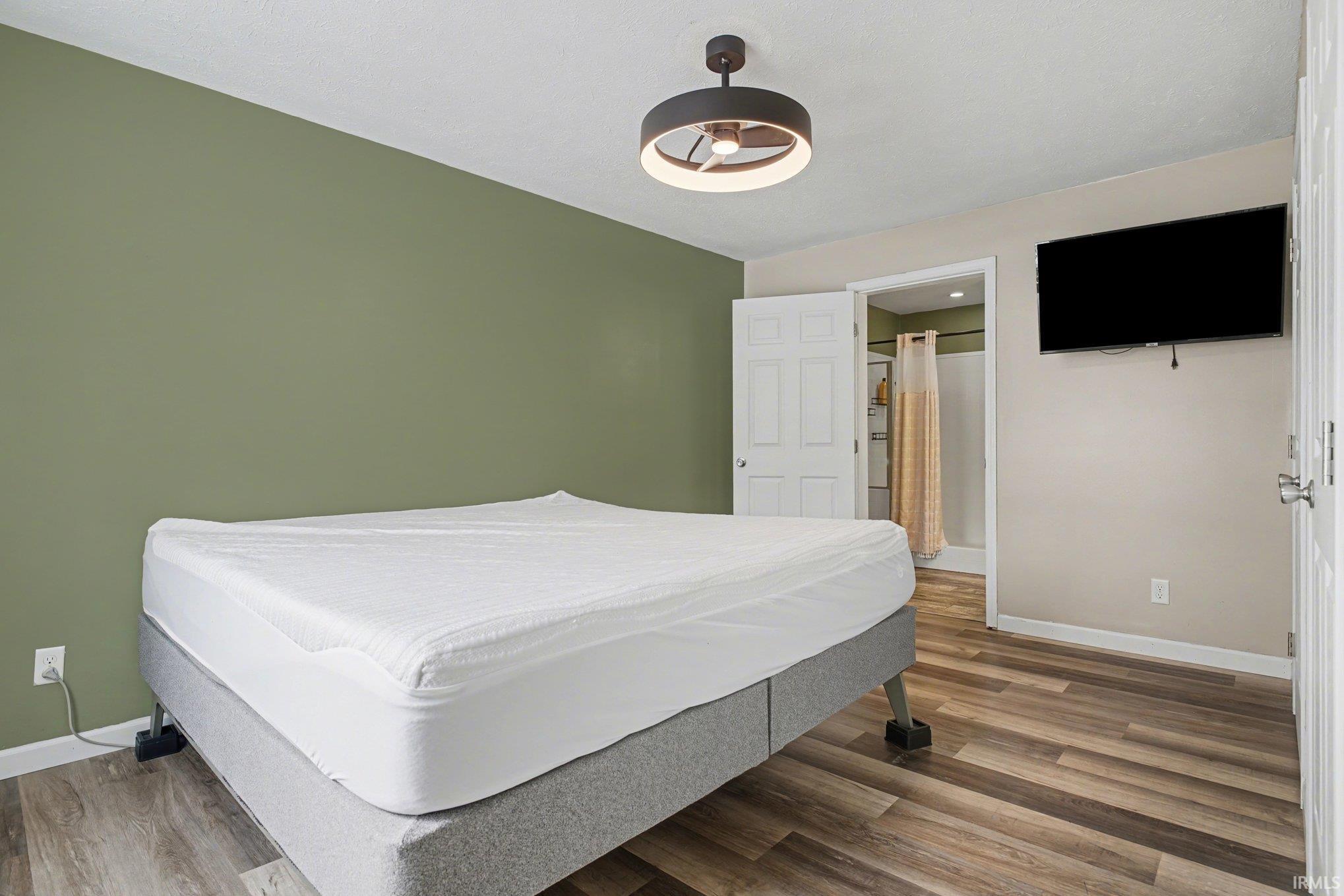 Bedroom with wood finished floors and ceiling fan