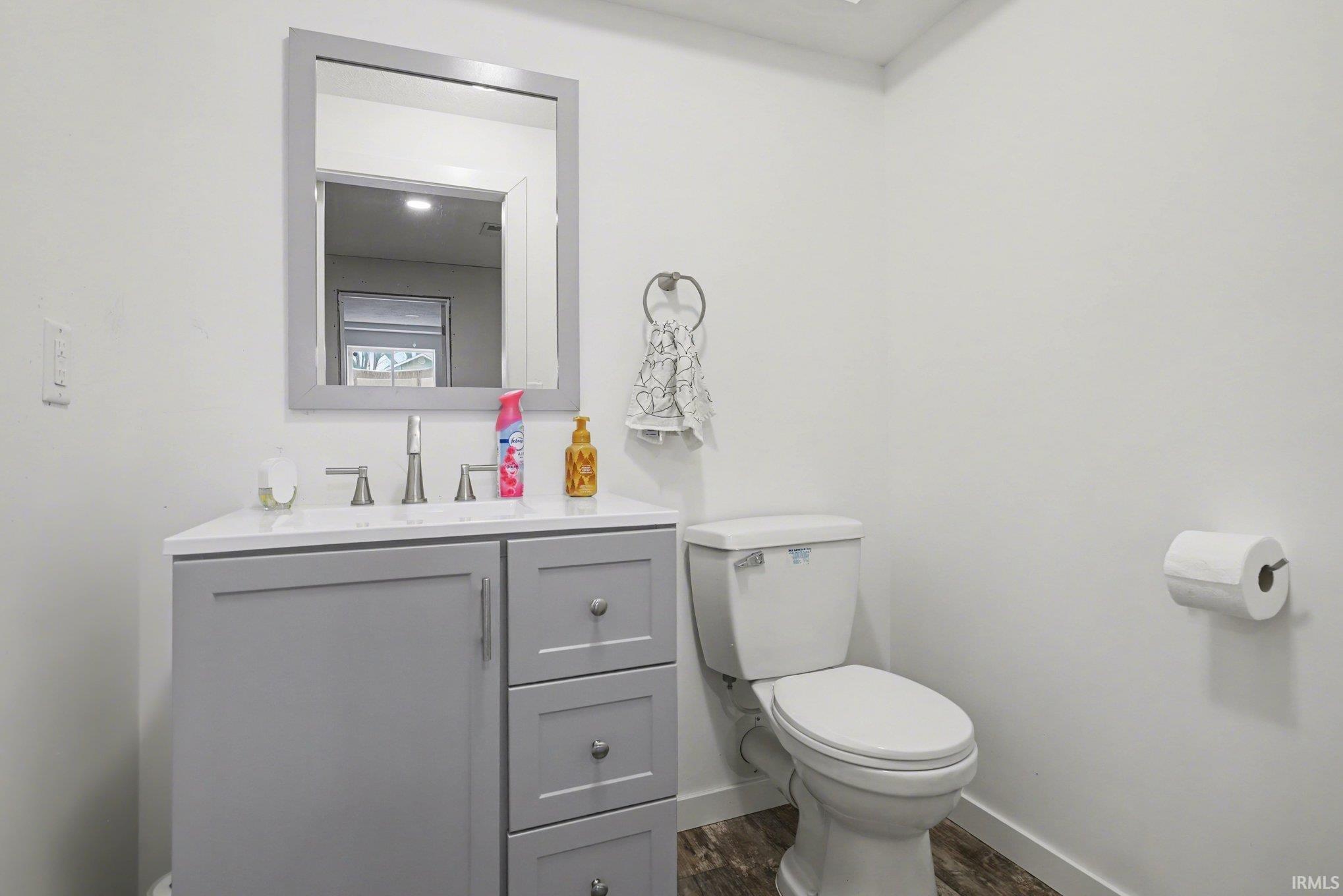 Bathroom with vanity and dark wood-style floors