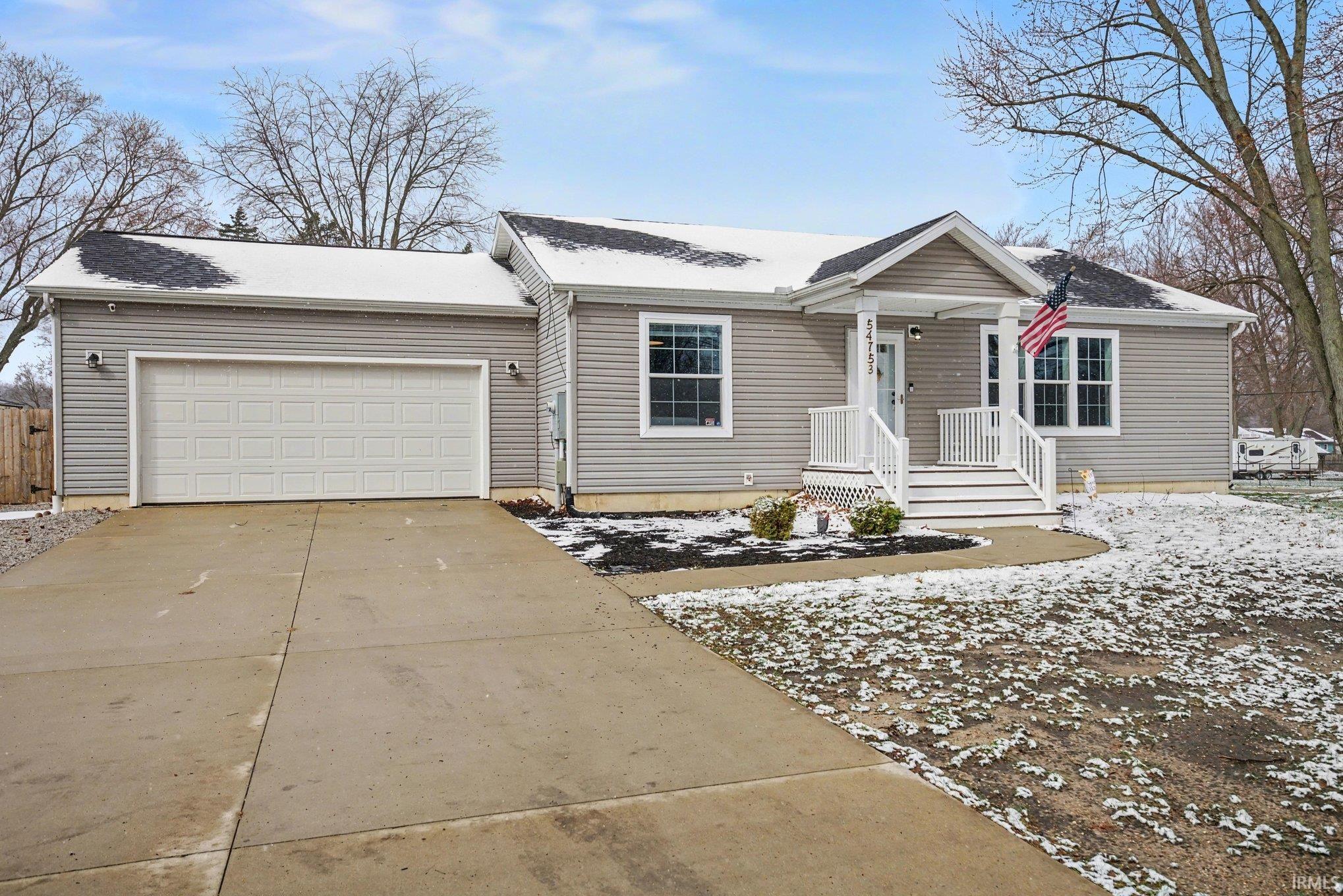 Ranch-style house with a garage and concrete driveway