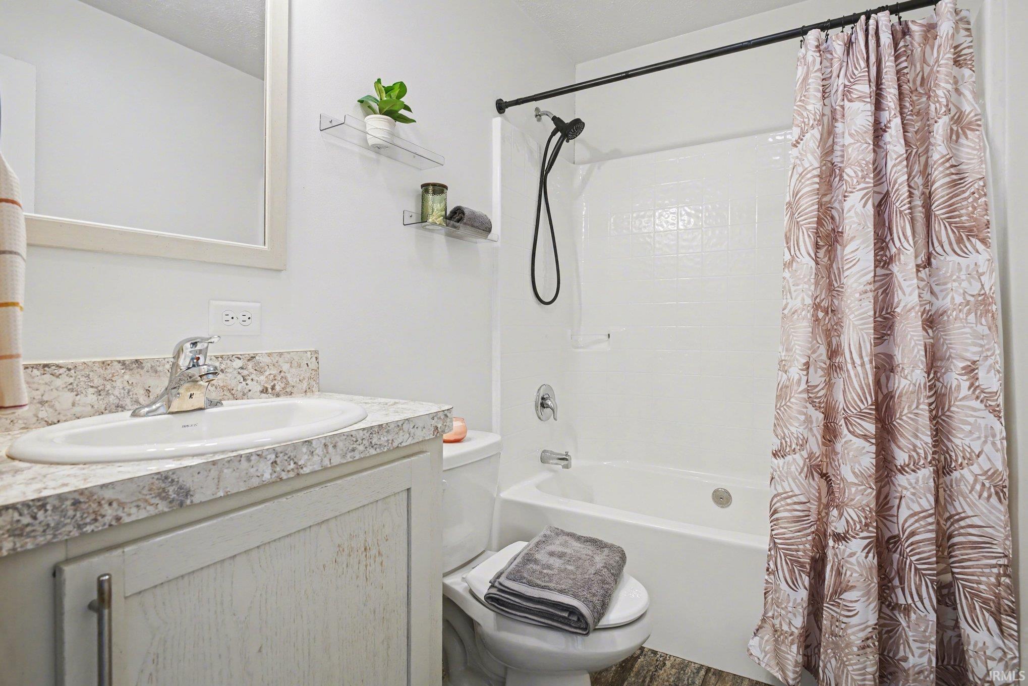 Bathroom featuring vanity and shower / tub combo