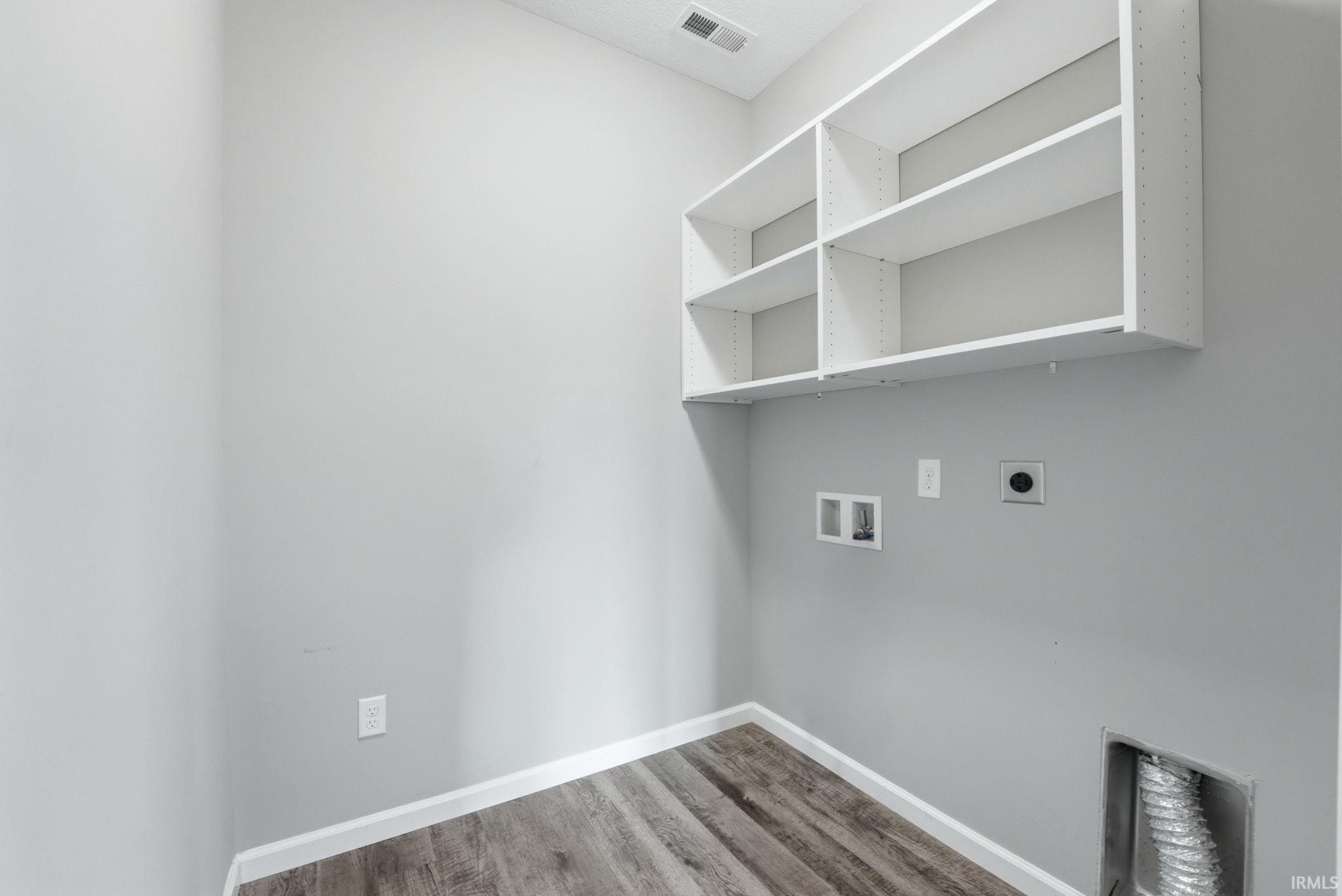 Laundry room featuring hookup for an electric dryer, light wood-style flooring, and washer hookup