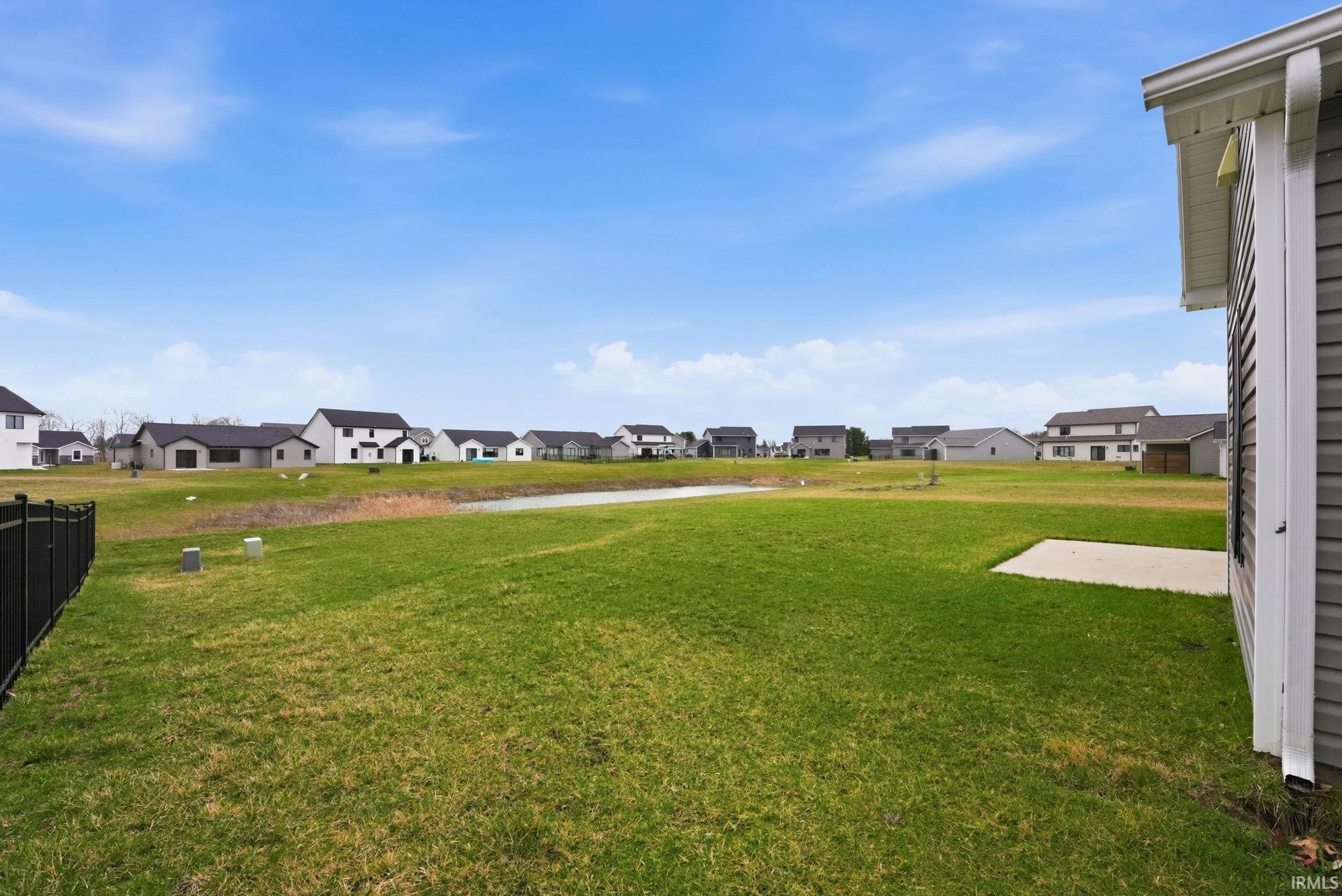 View of green lawn featuring a residential view