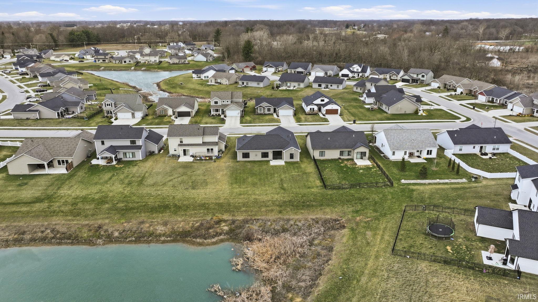 View of property location featuring a large body of water and nearby suburban area