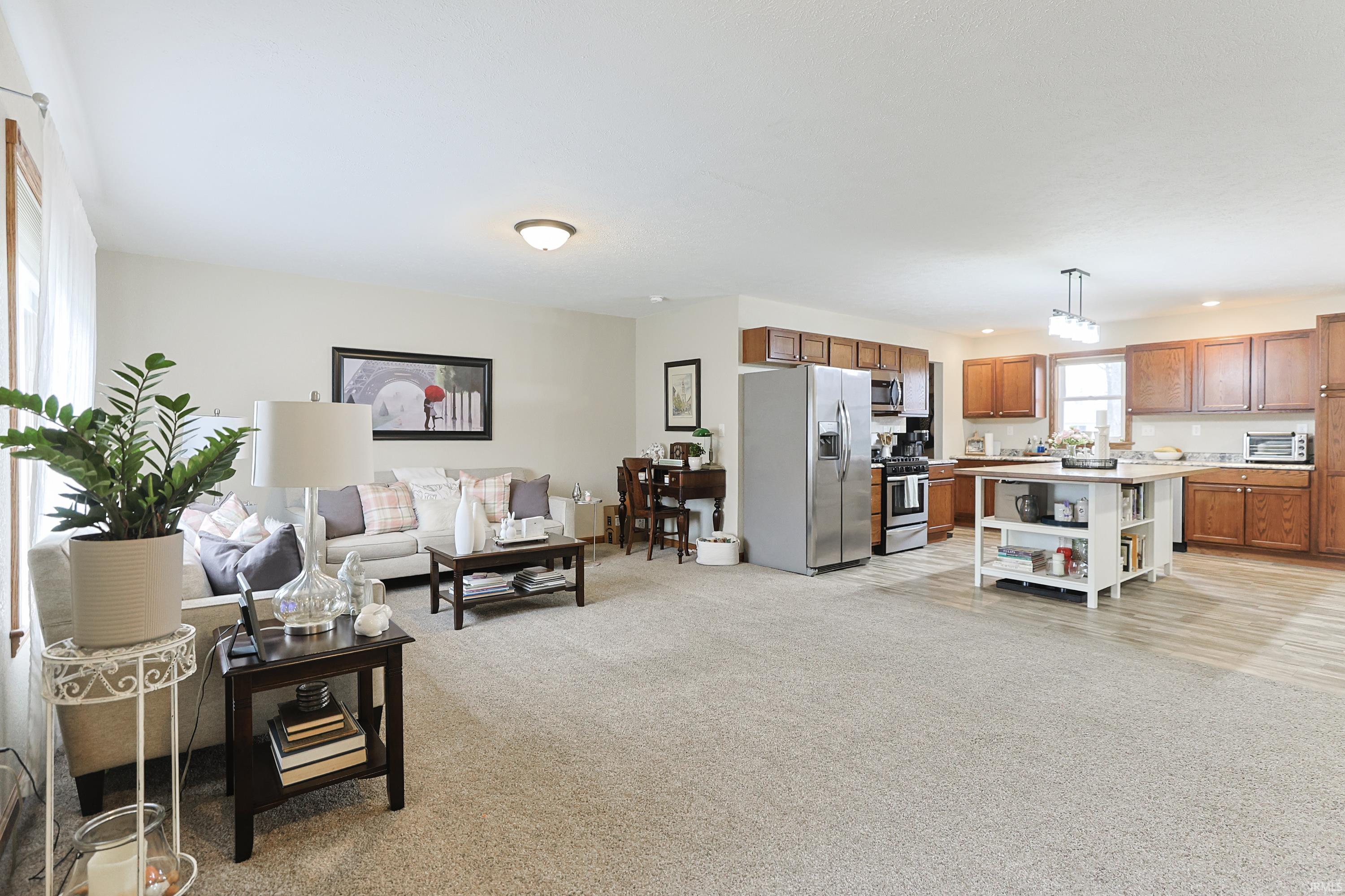 Living area featuring light carpet