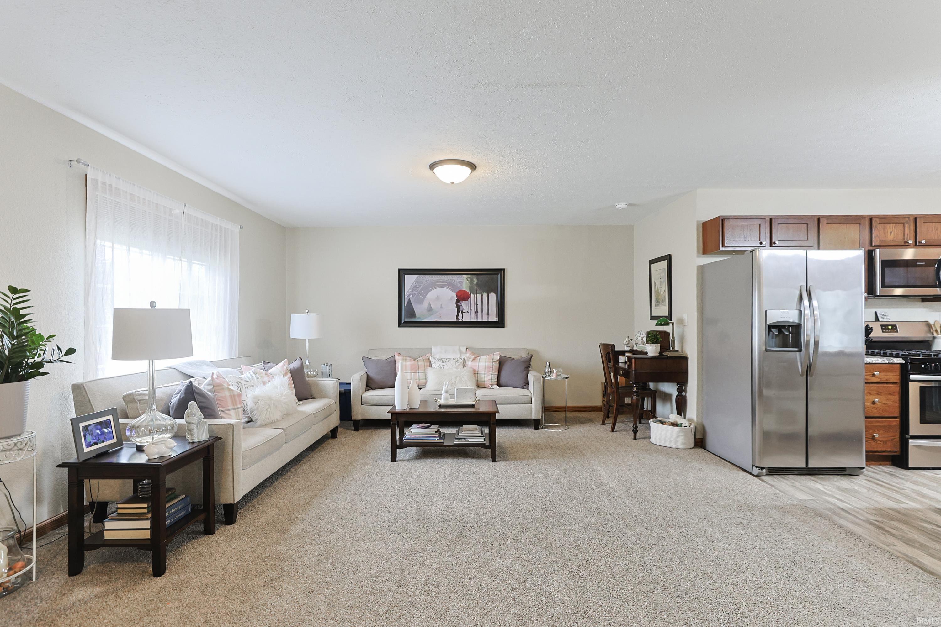 Living room featuring light carpet and baseboards