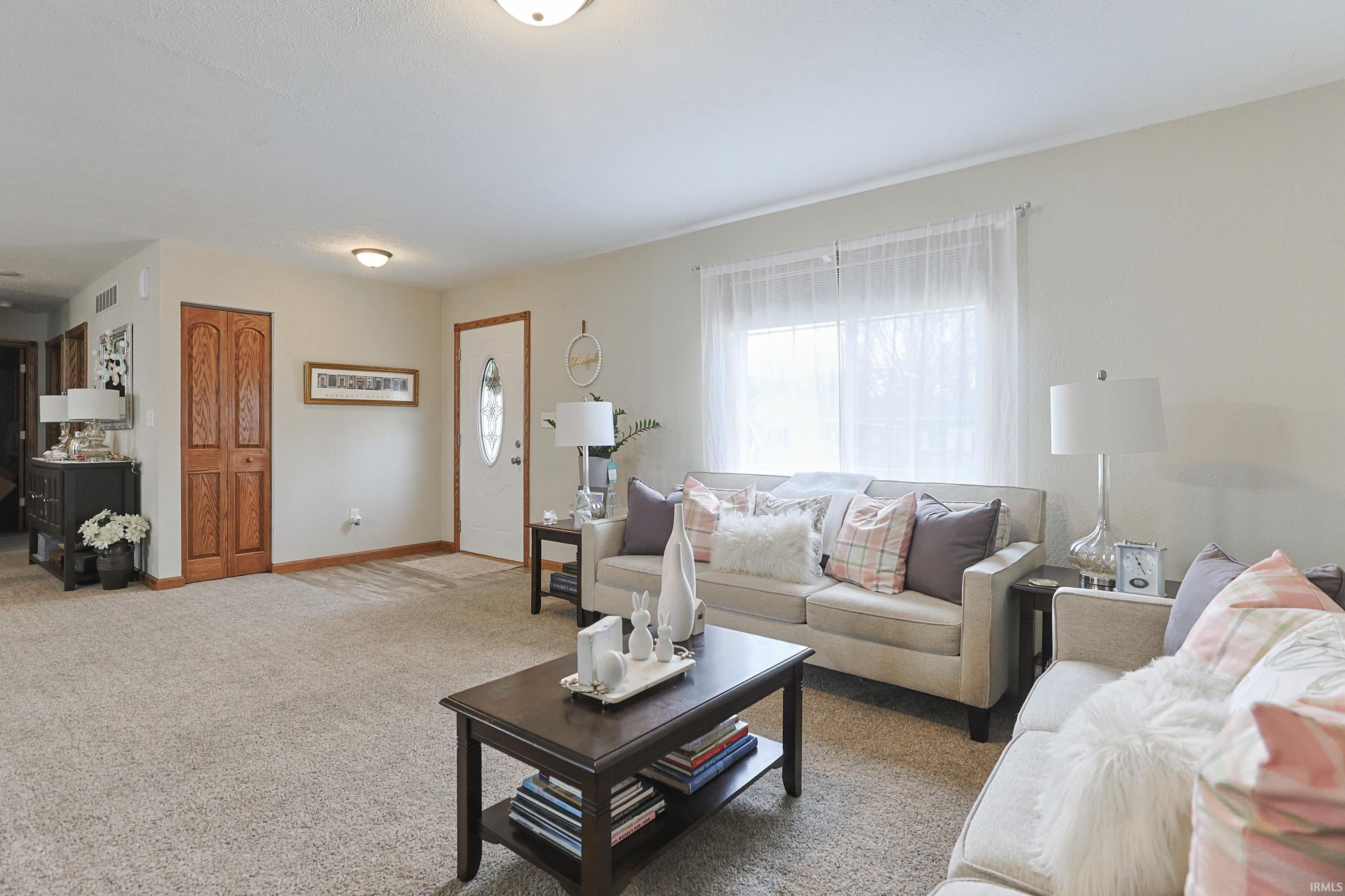Living area with carpet floors and baseboards