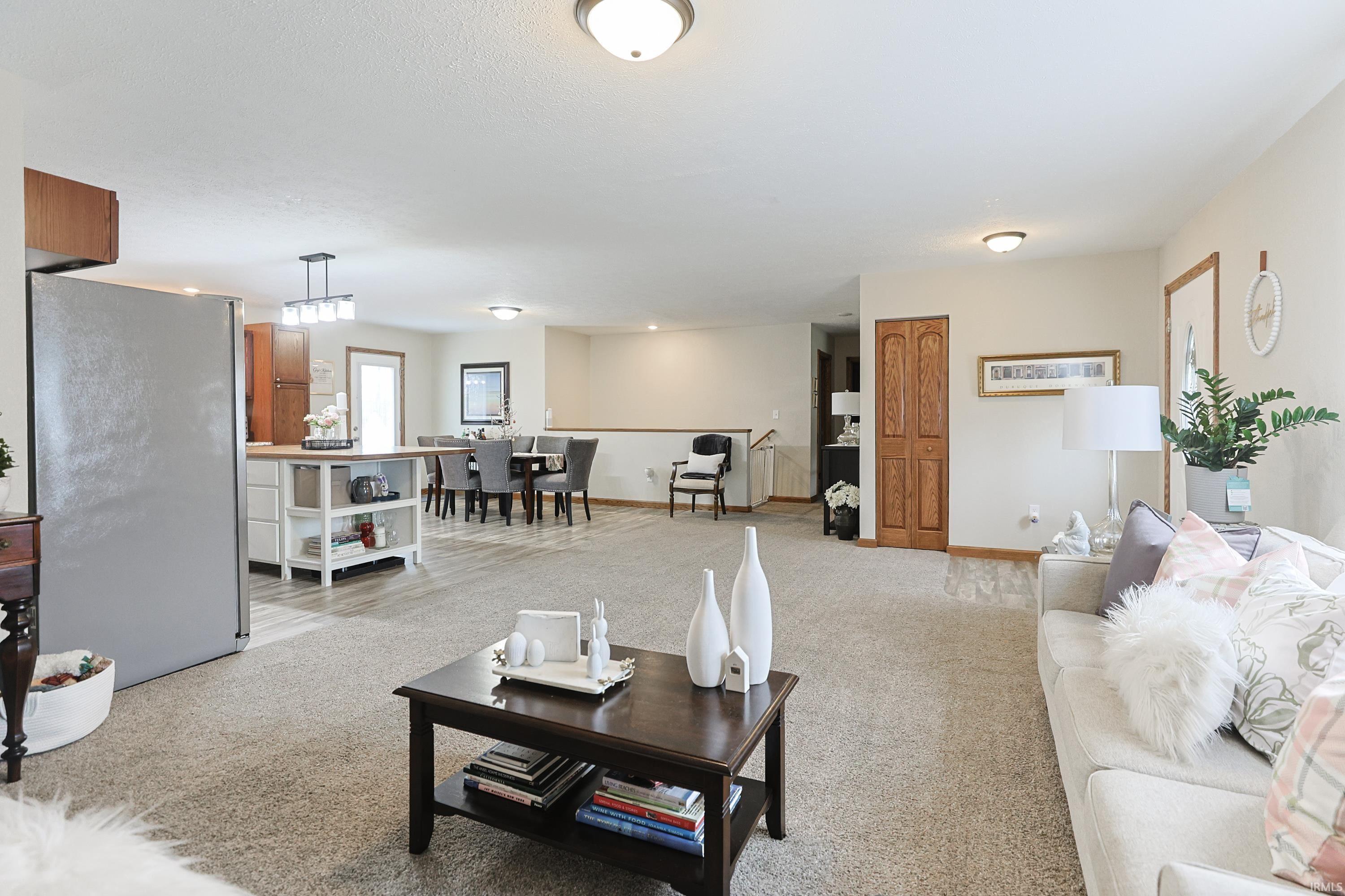 Living room featuring light carpet and baseboards