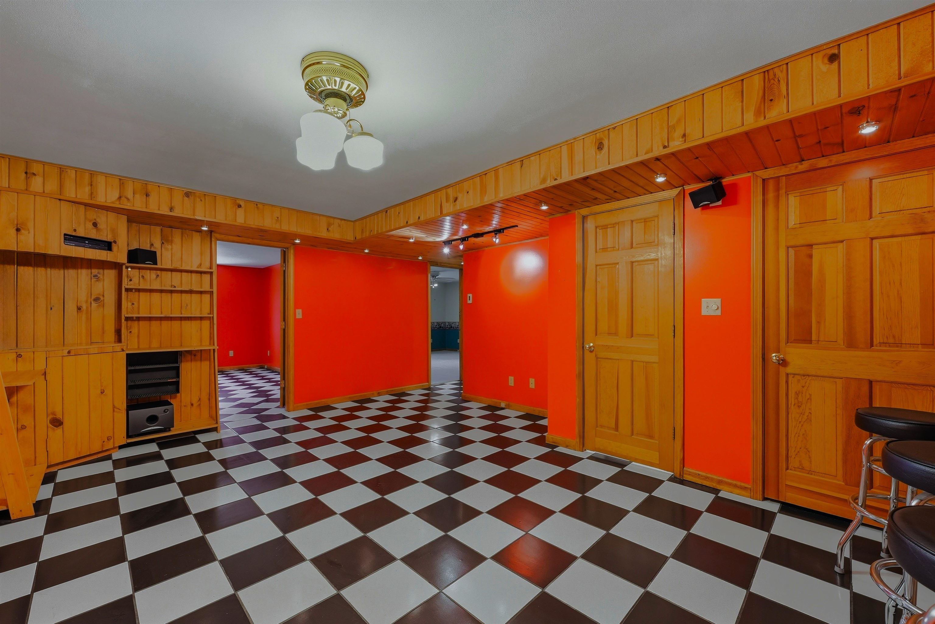 Spacious room with heated ceramic floors and wooden walls