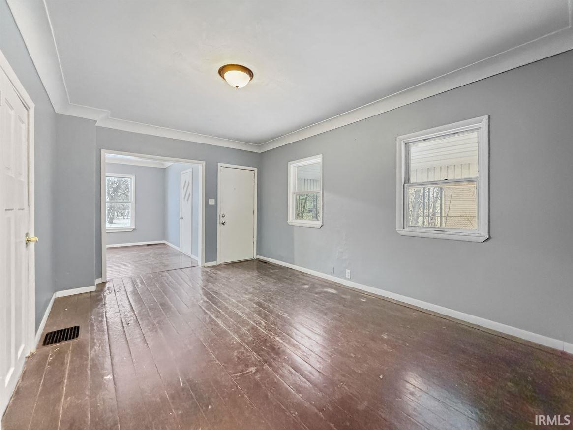 Foyer with baseboards and dark wood finished floors