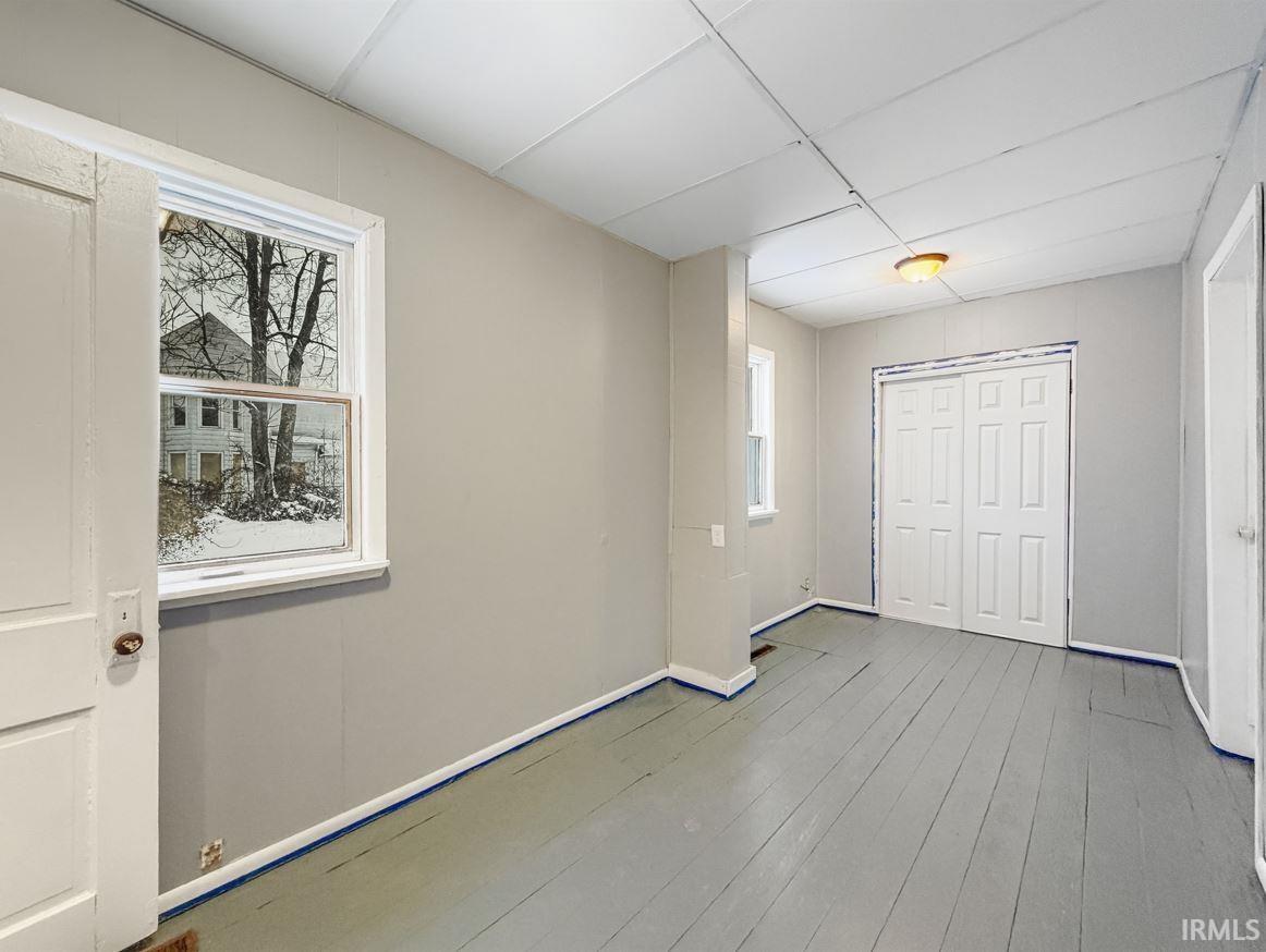 Unfurnished bedroom with light wood-style flooring and a closet