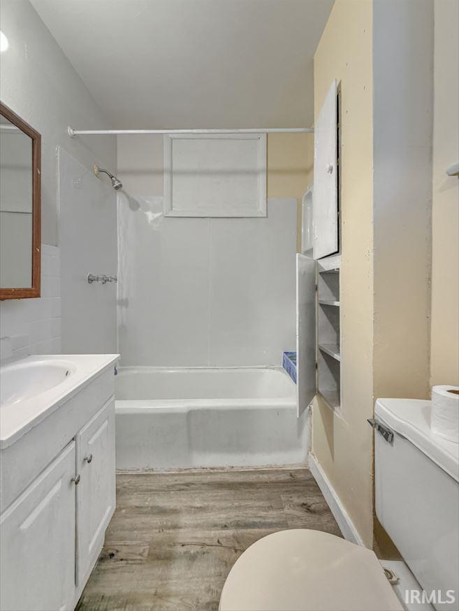 Bathroom featuring vanity, light wood-type flooring, and shower / bathtub combination