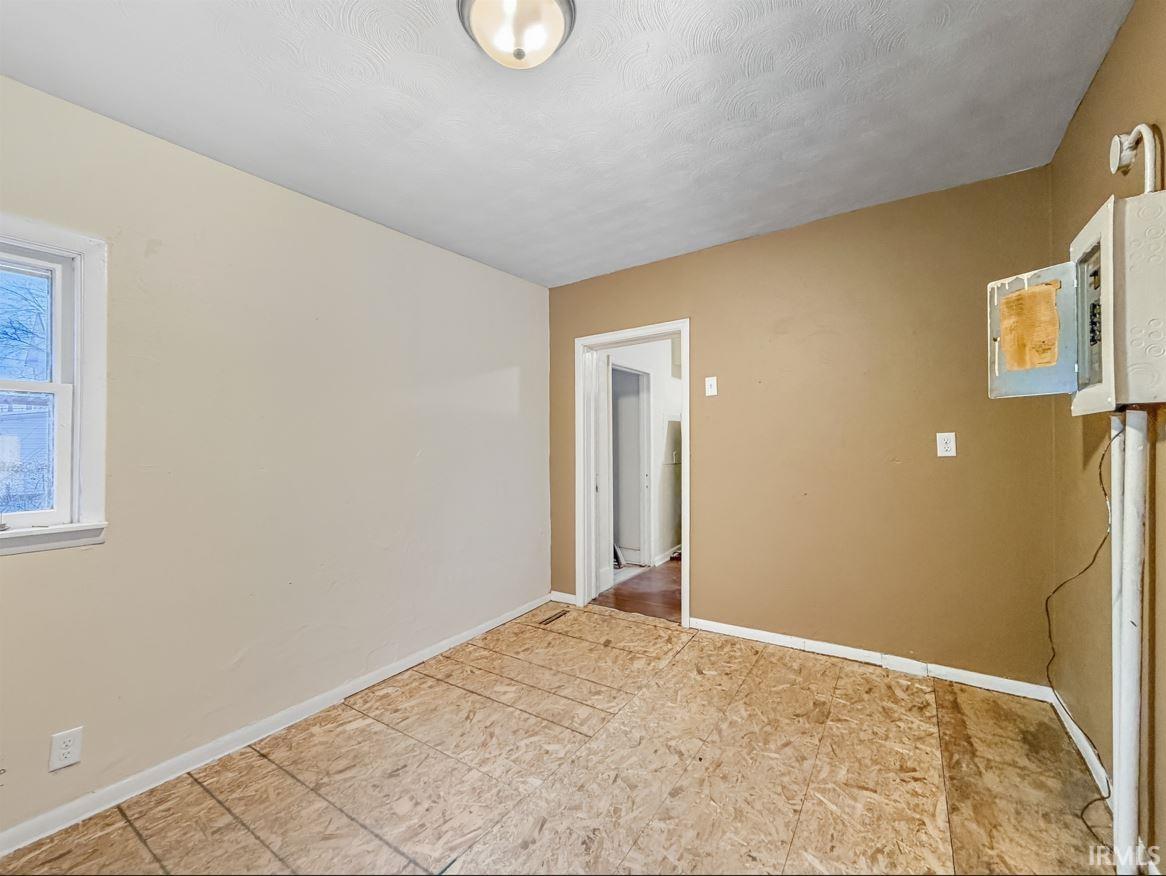 Unfurnished room with baseboards