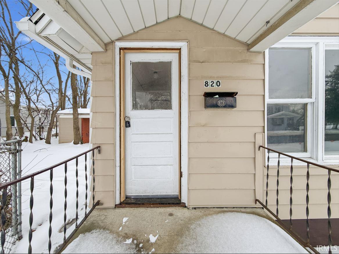 View of exterior entry with a porch