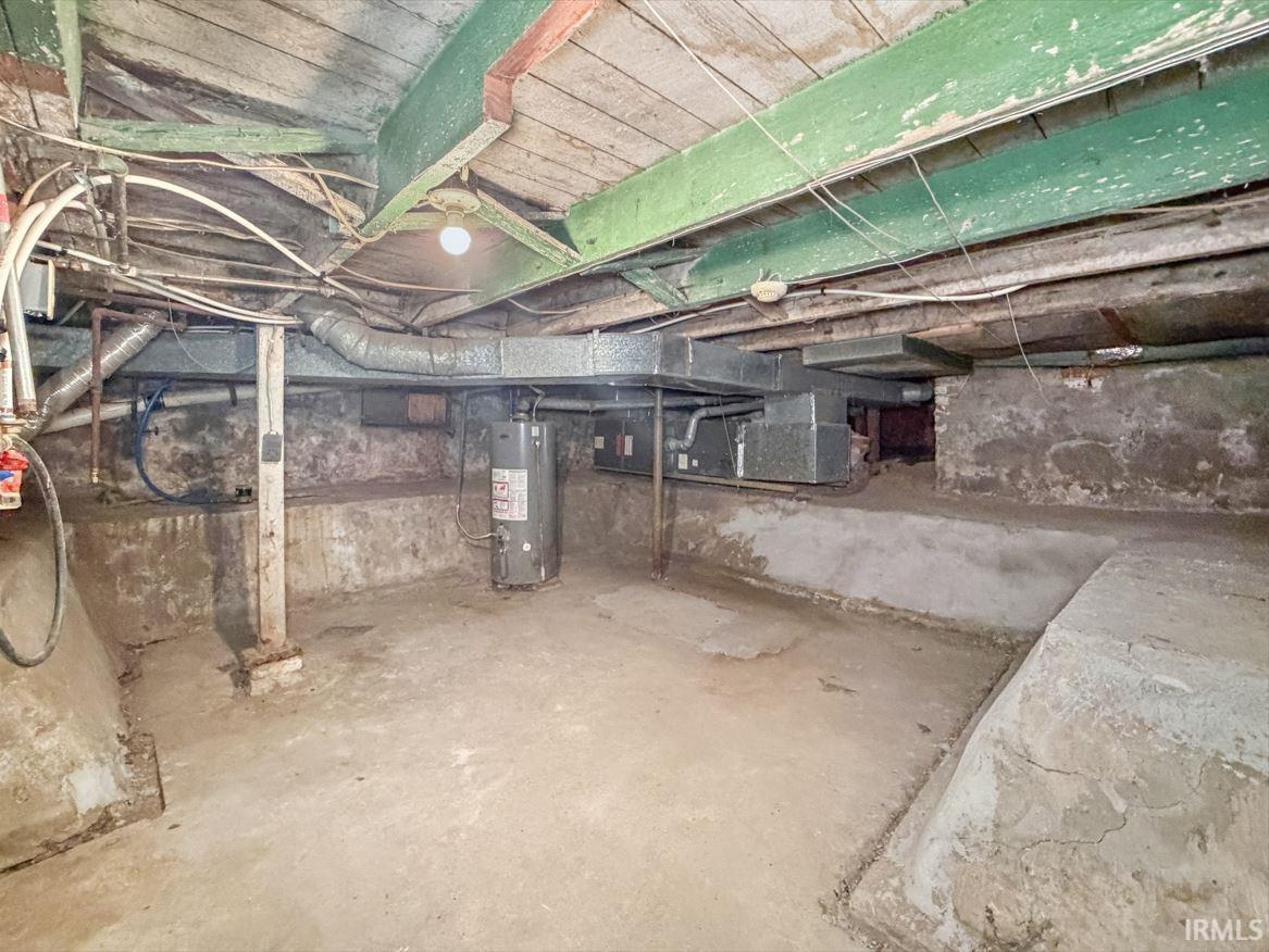 Unfinished below grade area featuring gas water heater