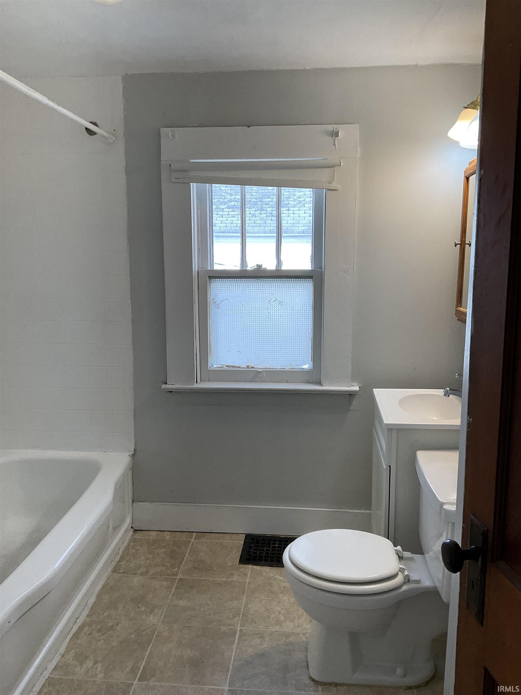 Bathroom featuring vanity and  shower combination