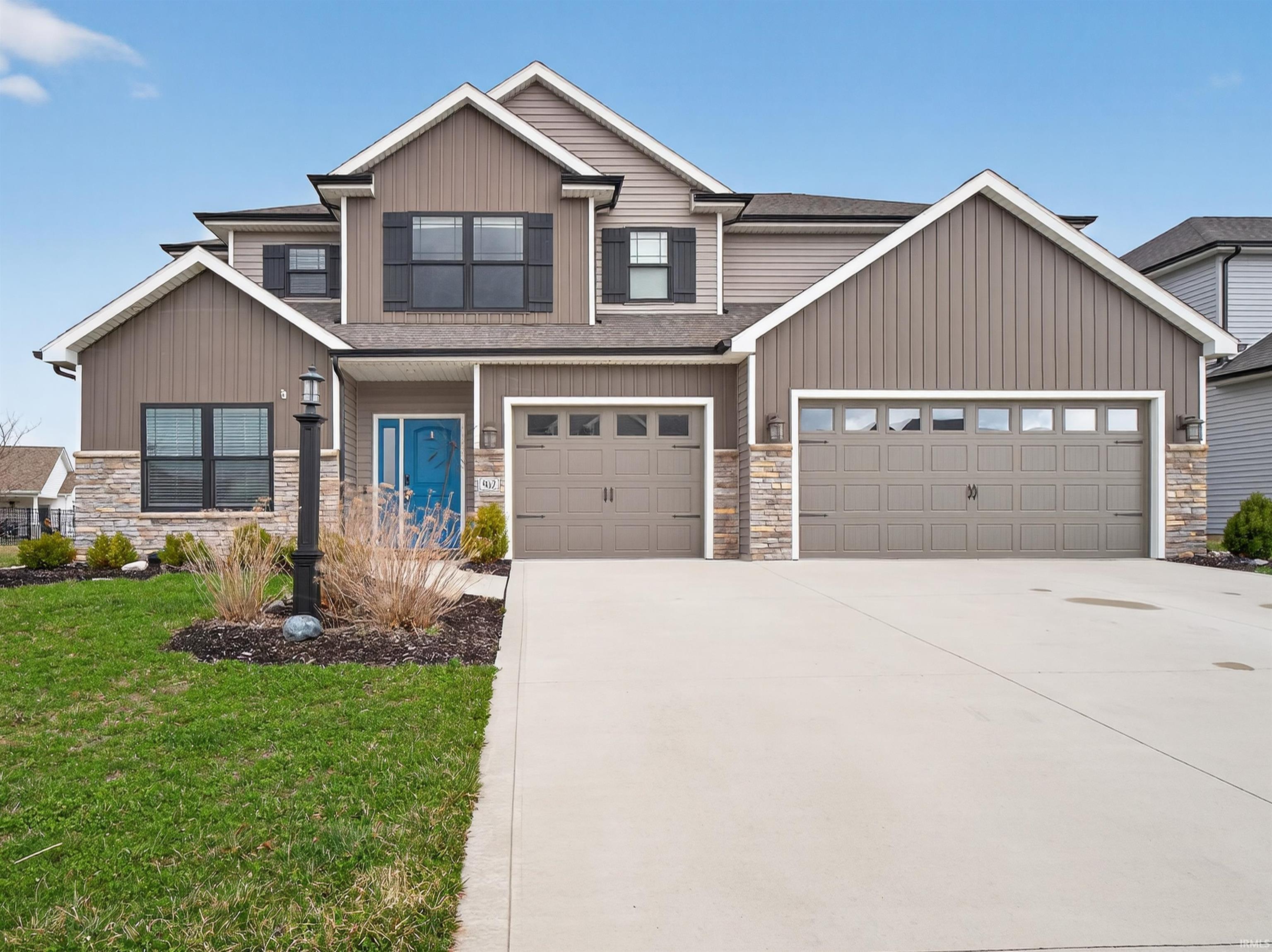 Craftsman inspired home with stone siding, concrete driveway, a shingled roof, a front lawn, and an attached garage