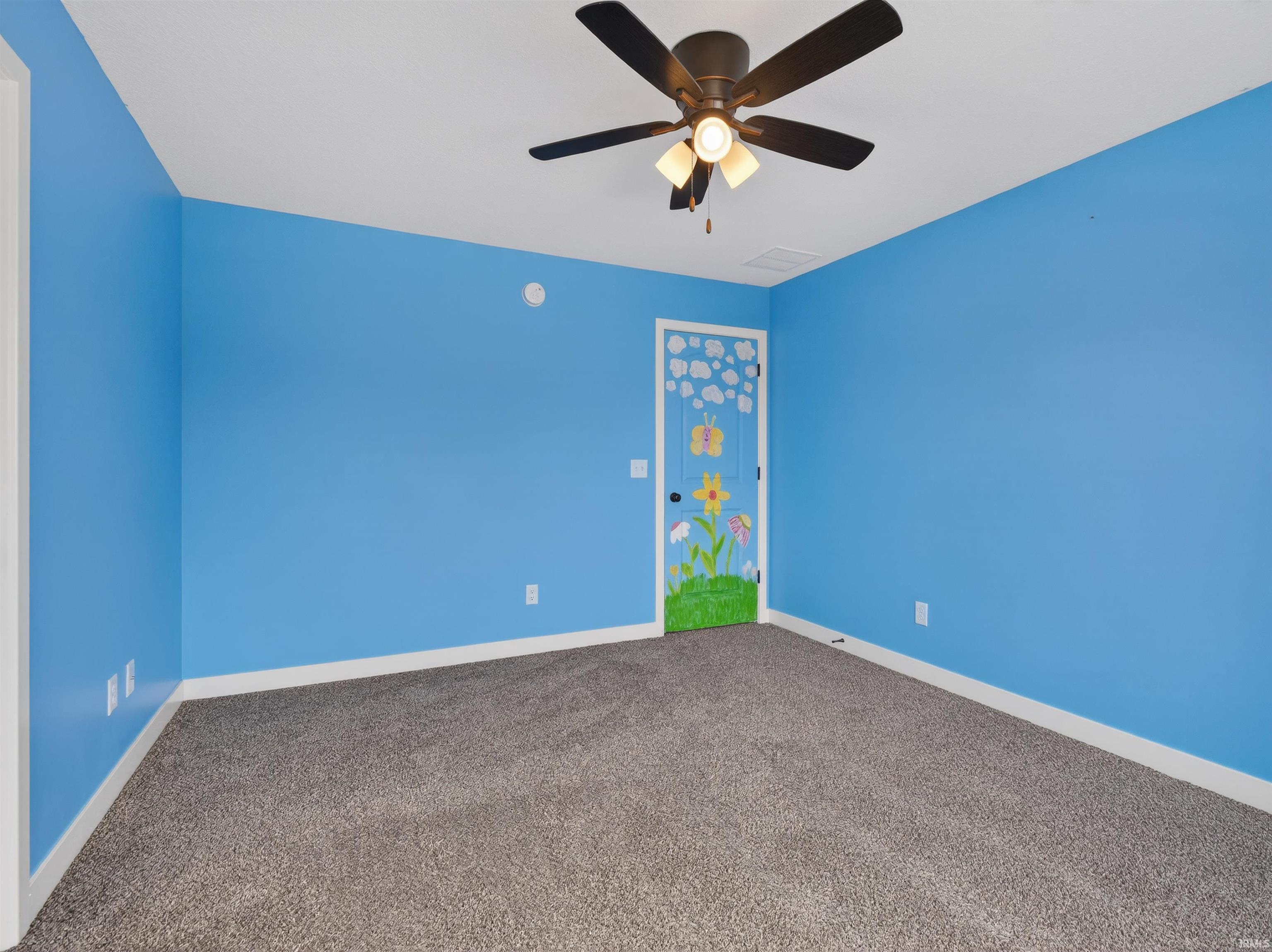 Spare room featuring a ceiling fan and carpet