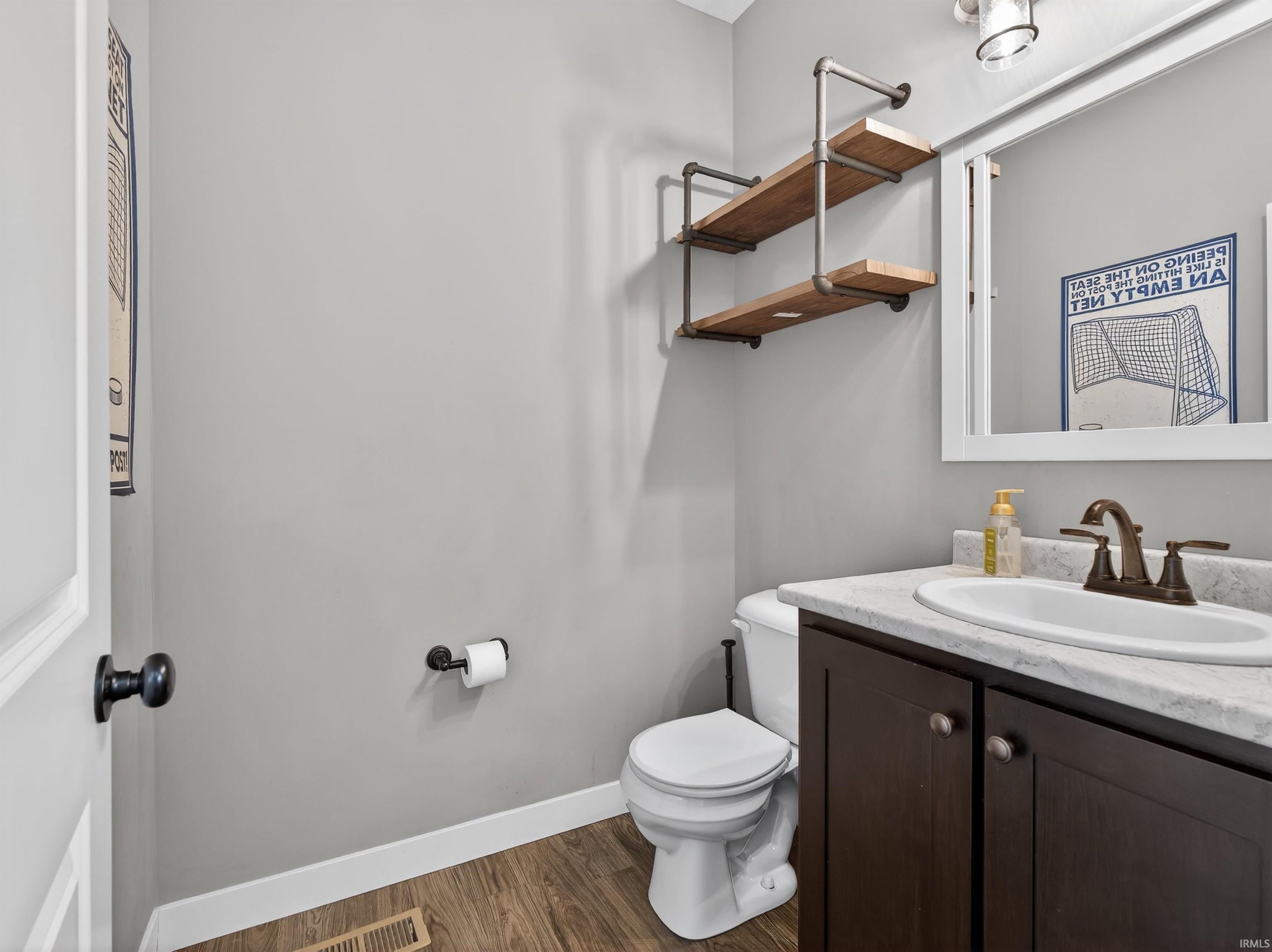 Bathroom featuring vanity and dark wood finished floors