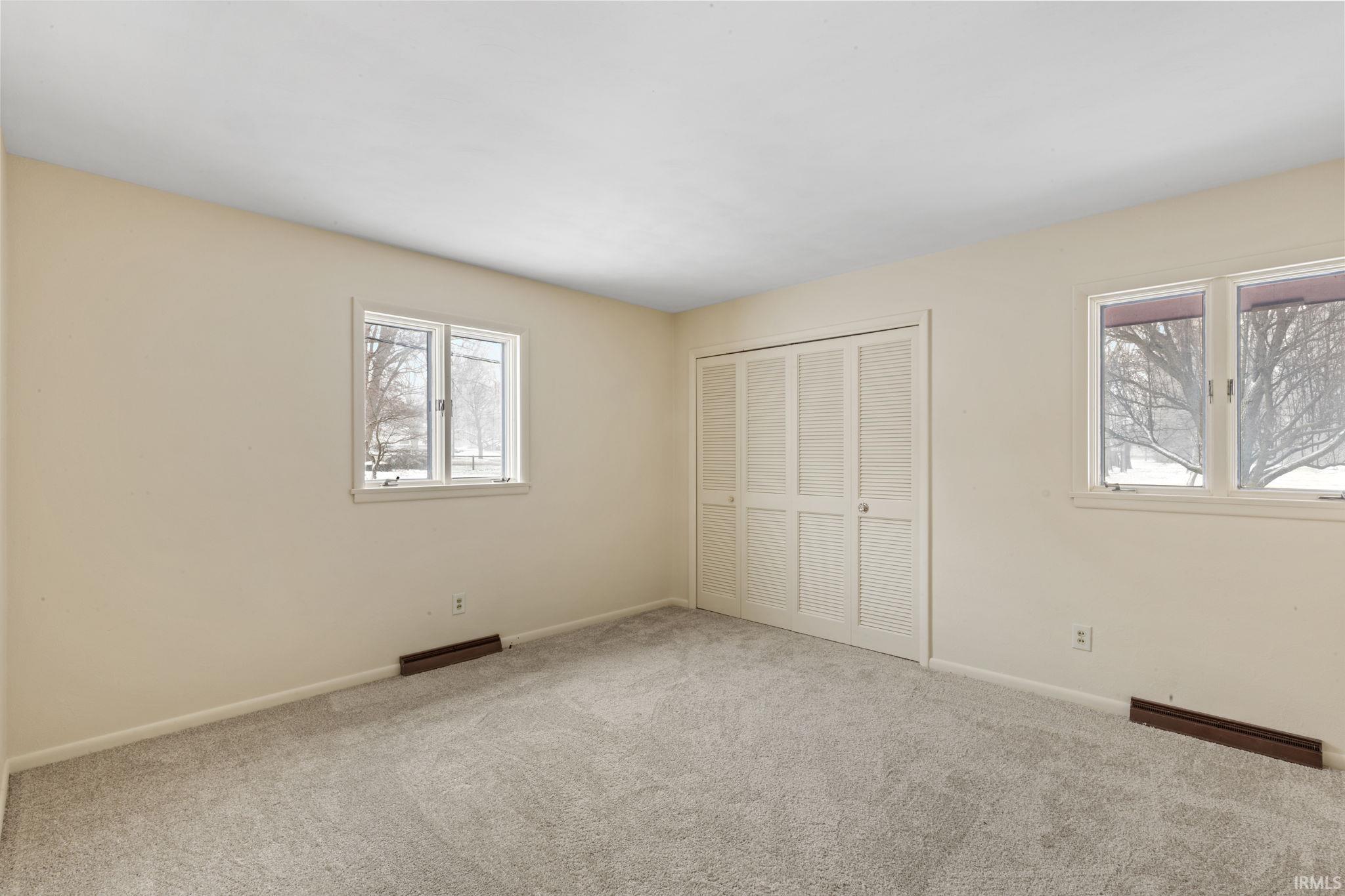 Unfurnished bedroom featuring carpet floors and a closet