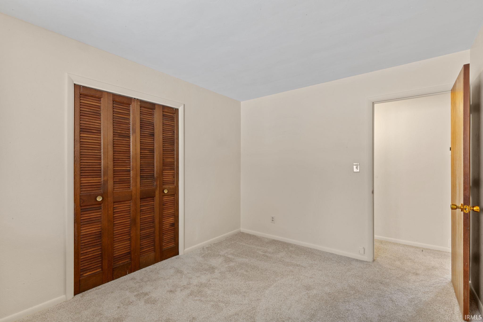 Unfurnished bedroom with carpet floors and a closet