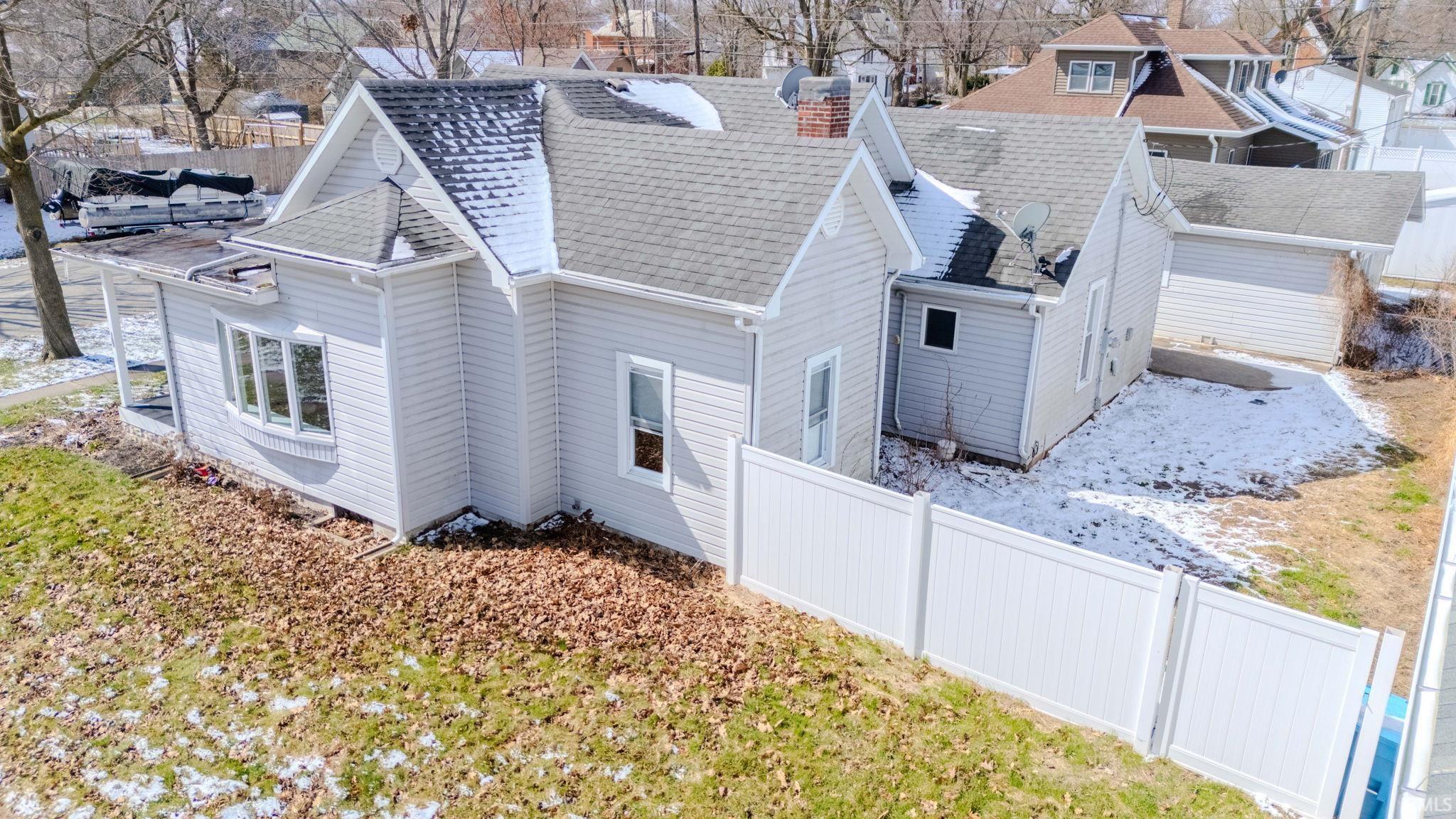 View of home's exterior roof with shingles, and a residential view