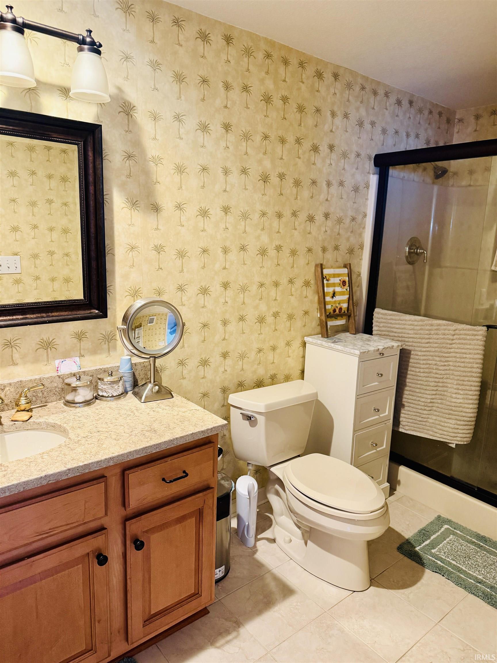 Full bathroom featuring vanity, a shower stall, and light tile patterned floors