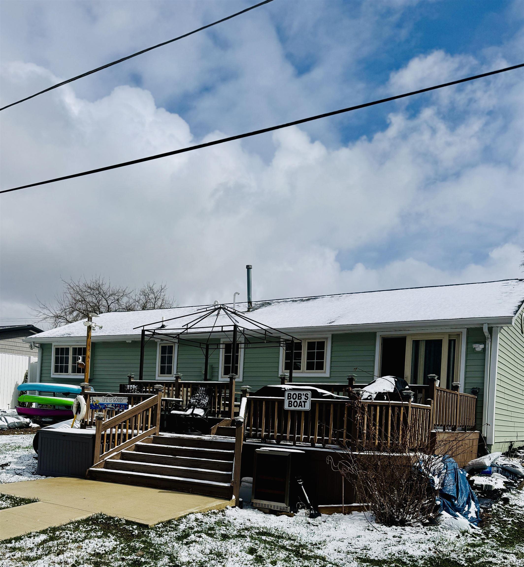 View of front of property with a wooden deck