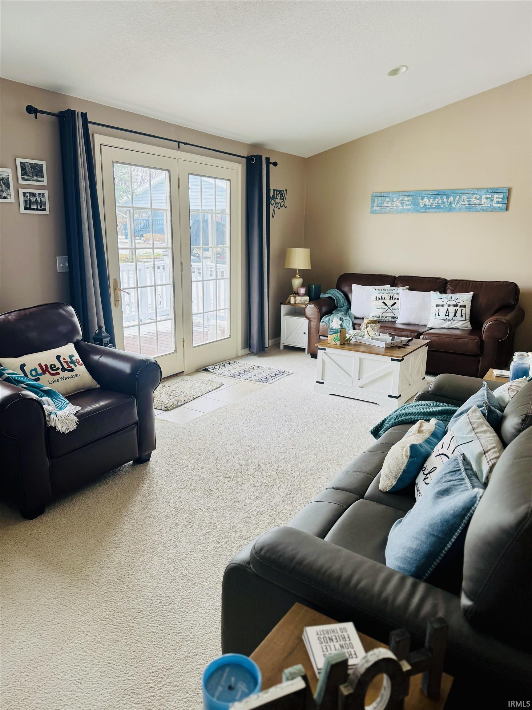 Living room with carpet flooring and french doors