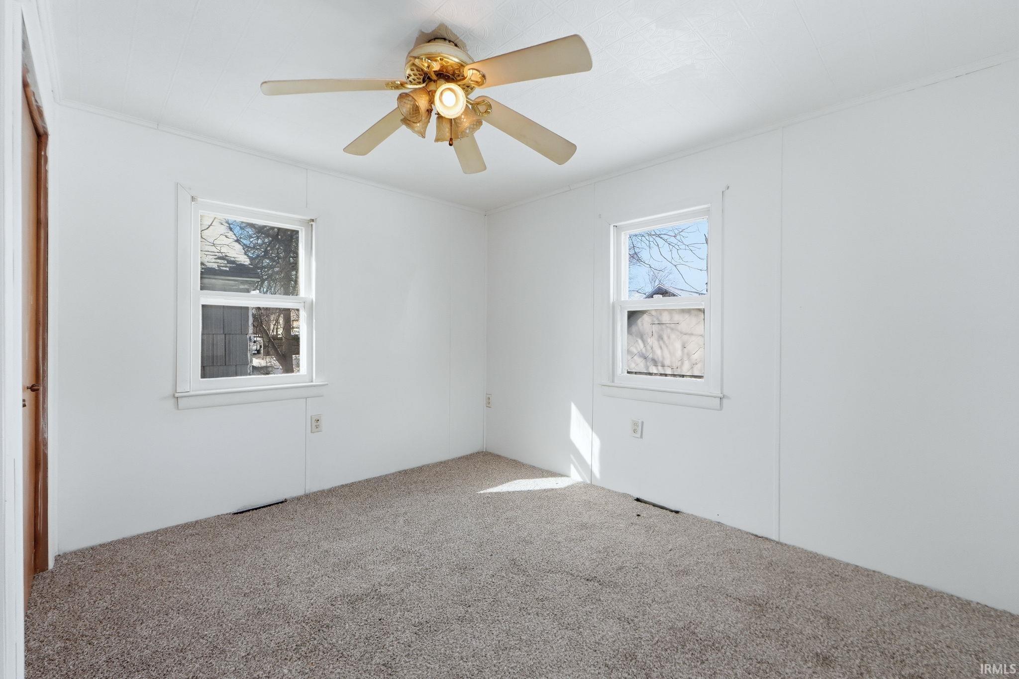 Unfurnished room with carpet floors and ceiling fan