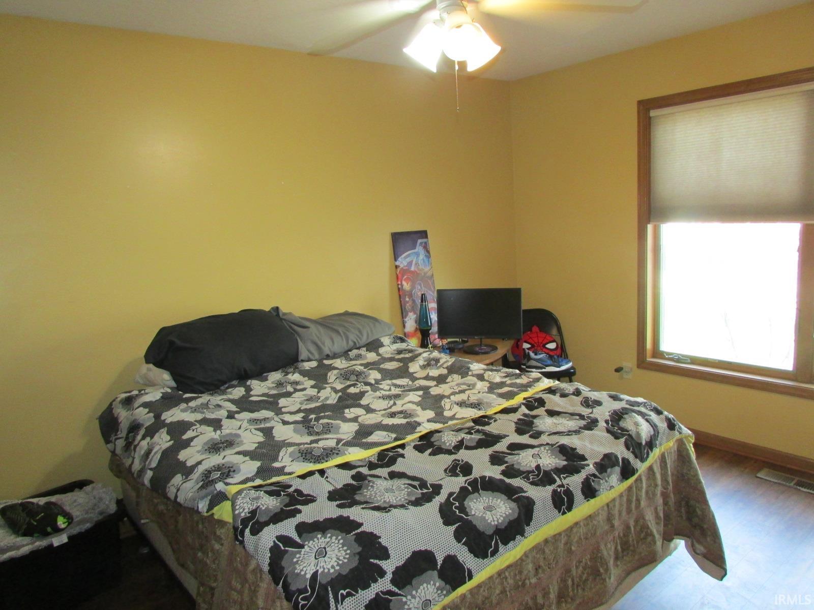 Bedroom featuring wood finished floors and a ceiling fan