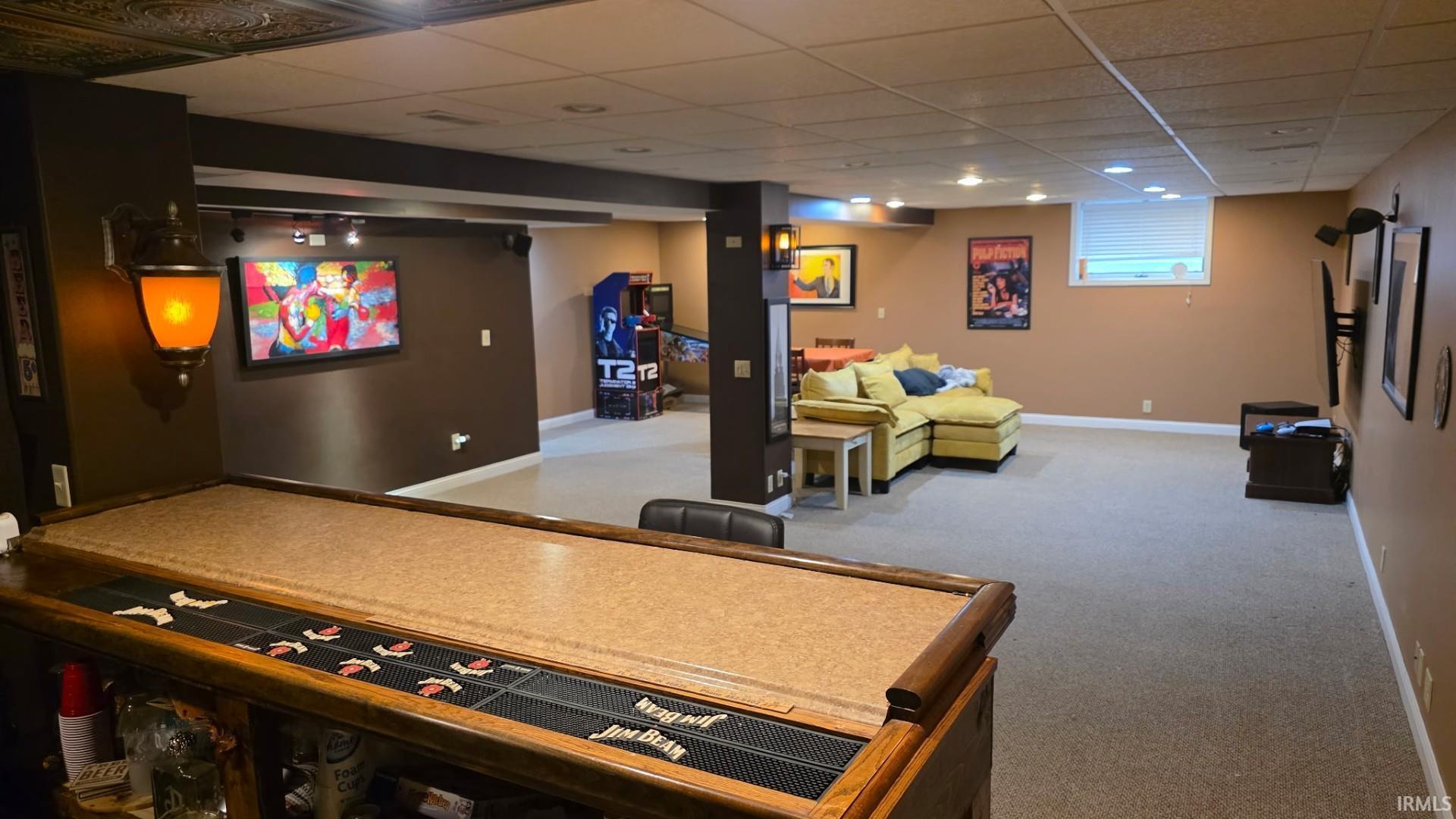 Game room with light colored carpet and a drop ceiling