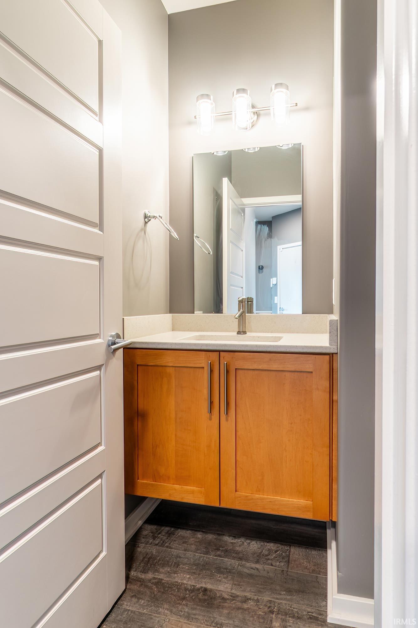 Bathroom with vanity and dark wood-type flooring