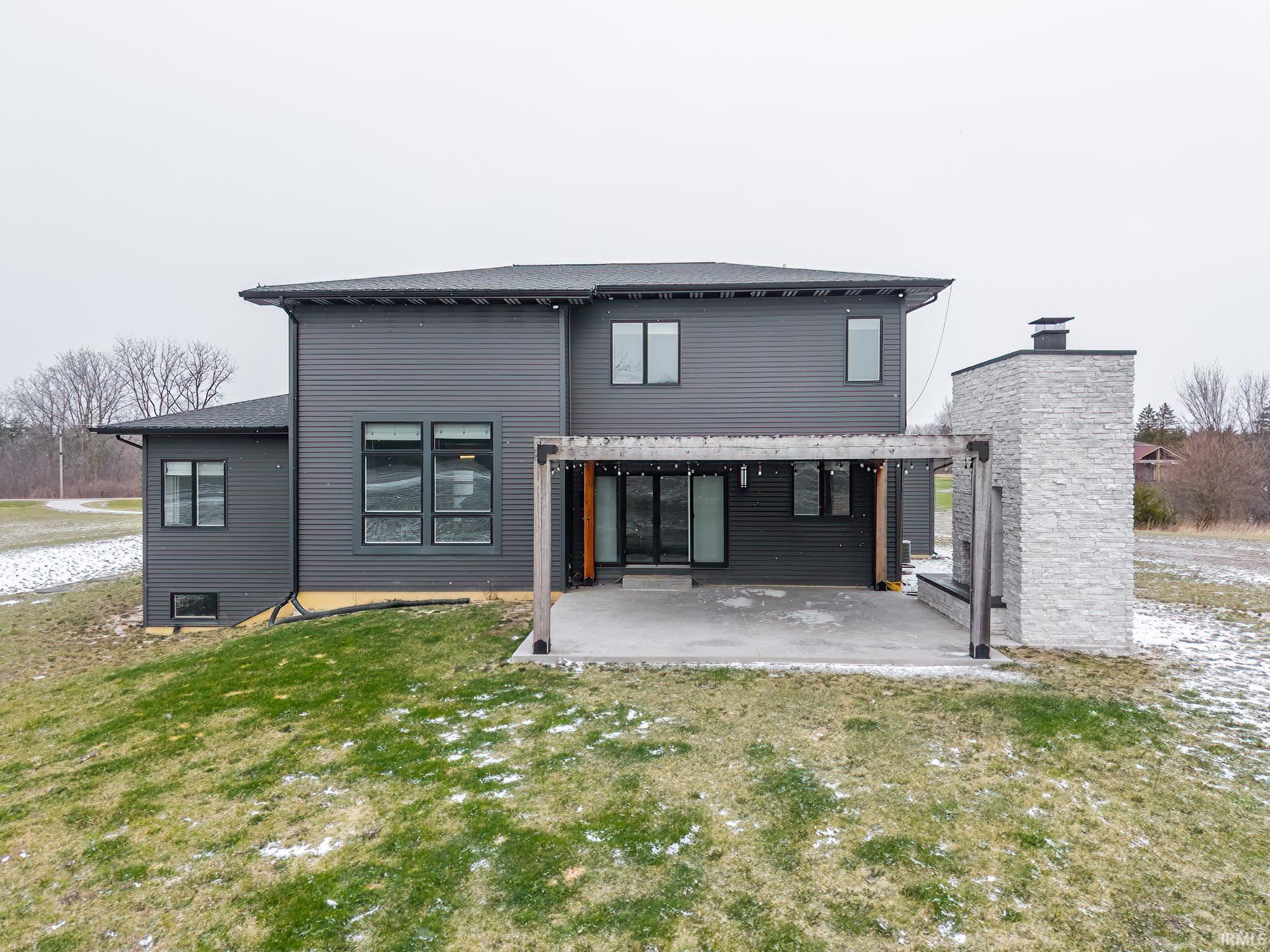 Back of house featuring a lawn, a patio area, and a pergola
