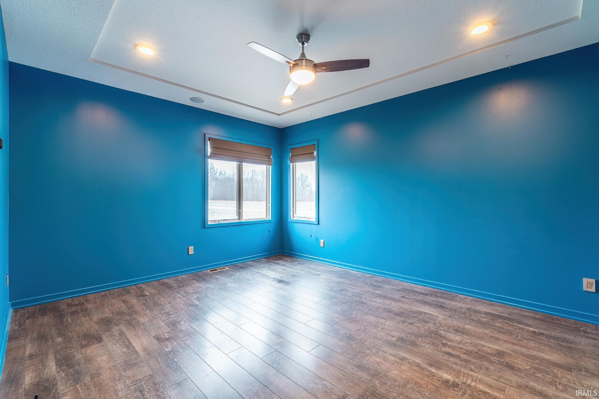 Unfurnished room with a ceiling fan, dark wood finished floors, and recessed lighting