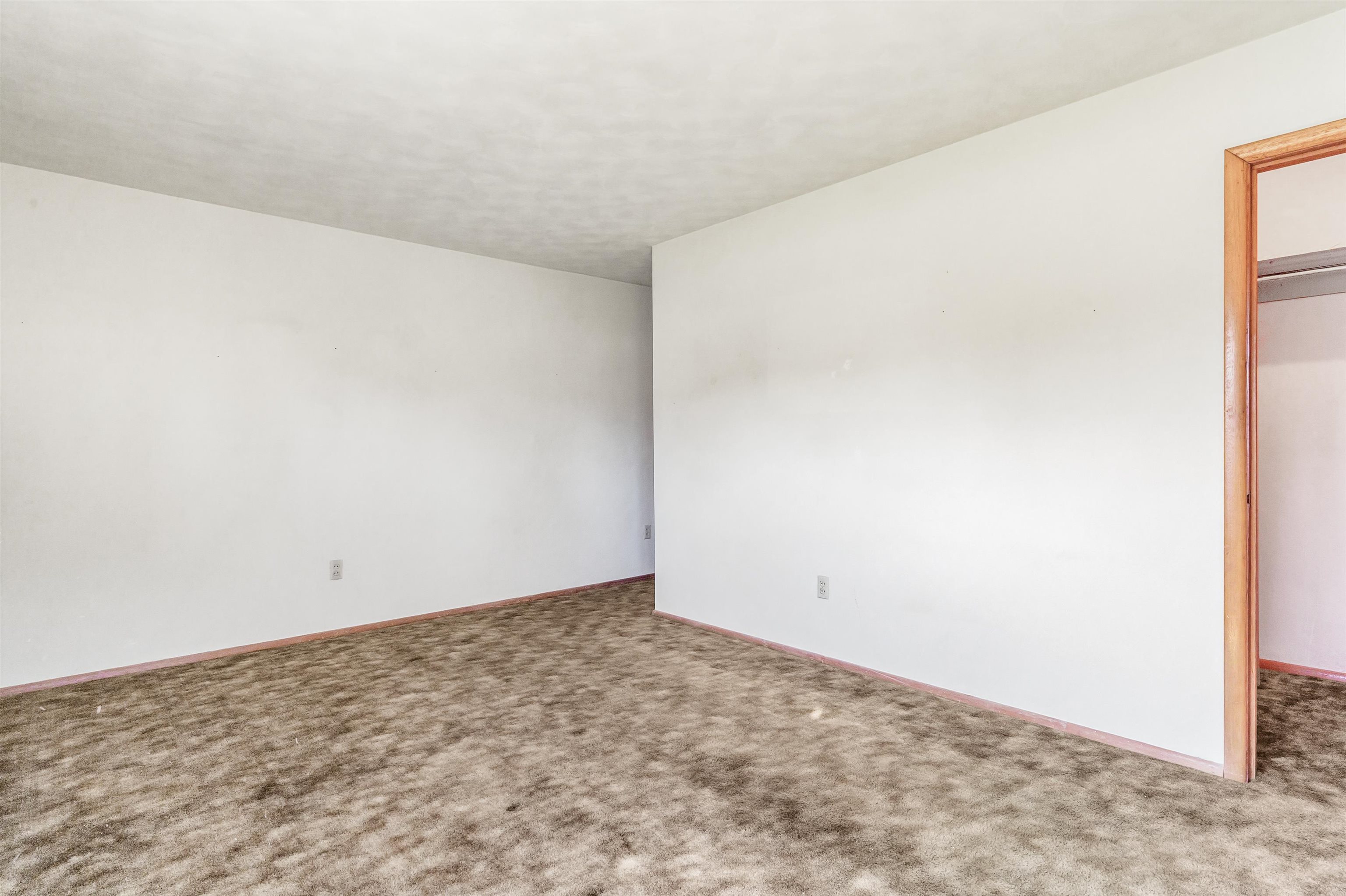 Unfurnished bedroom featuring carpet flooring and a closet