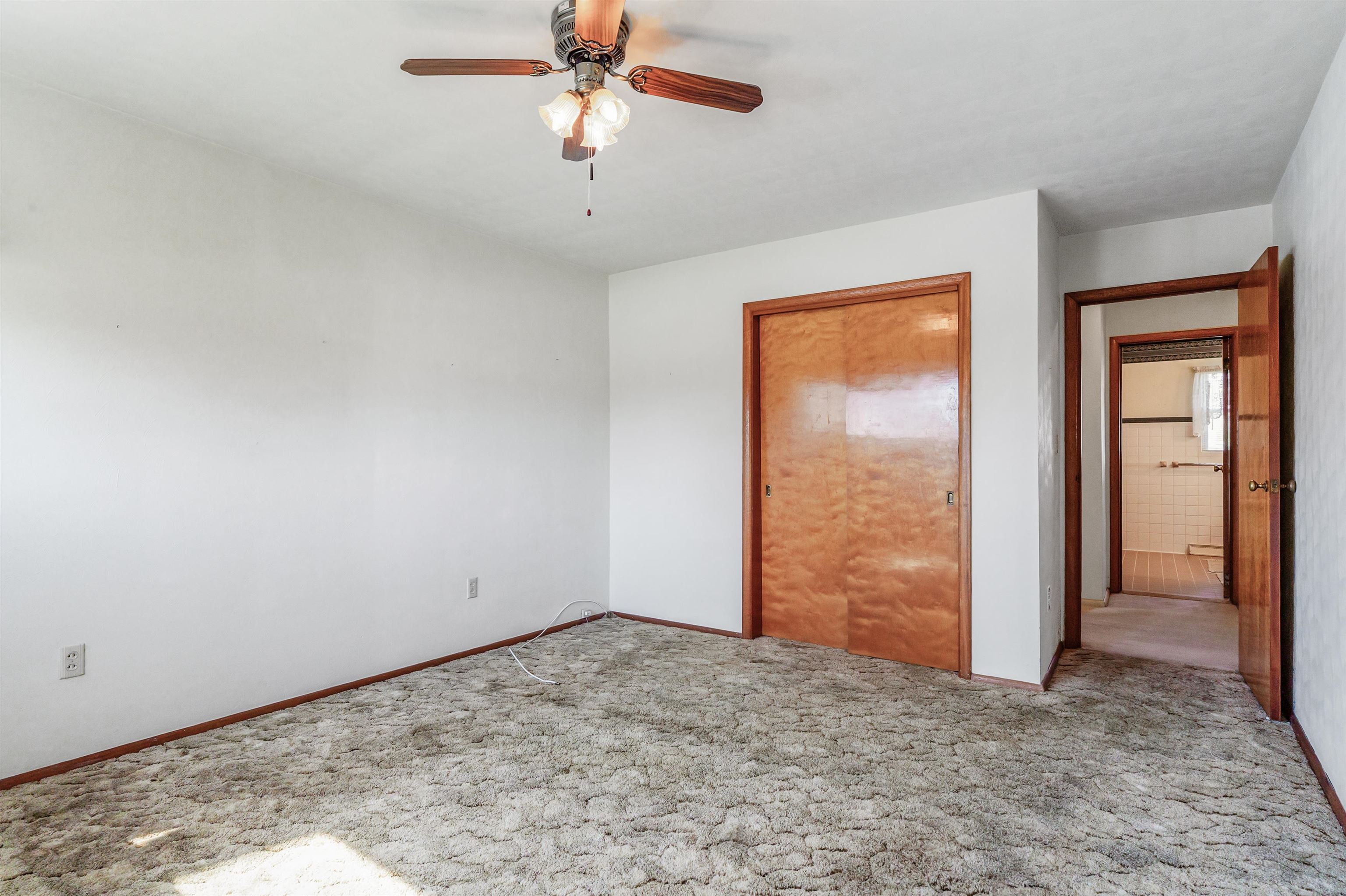 Unfurnished bedroom featuring carpet flooring and a ceiling fan