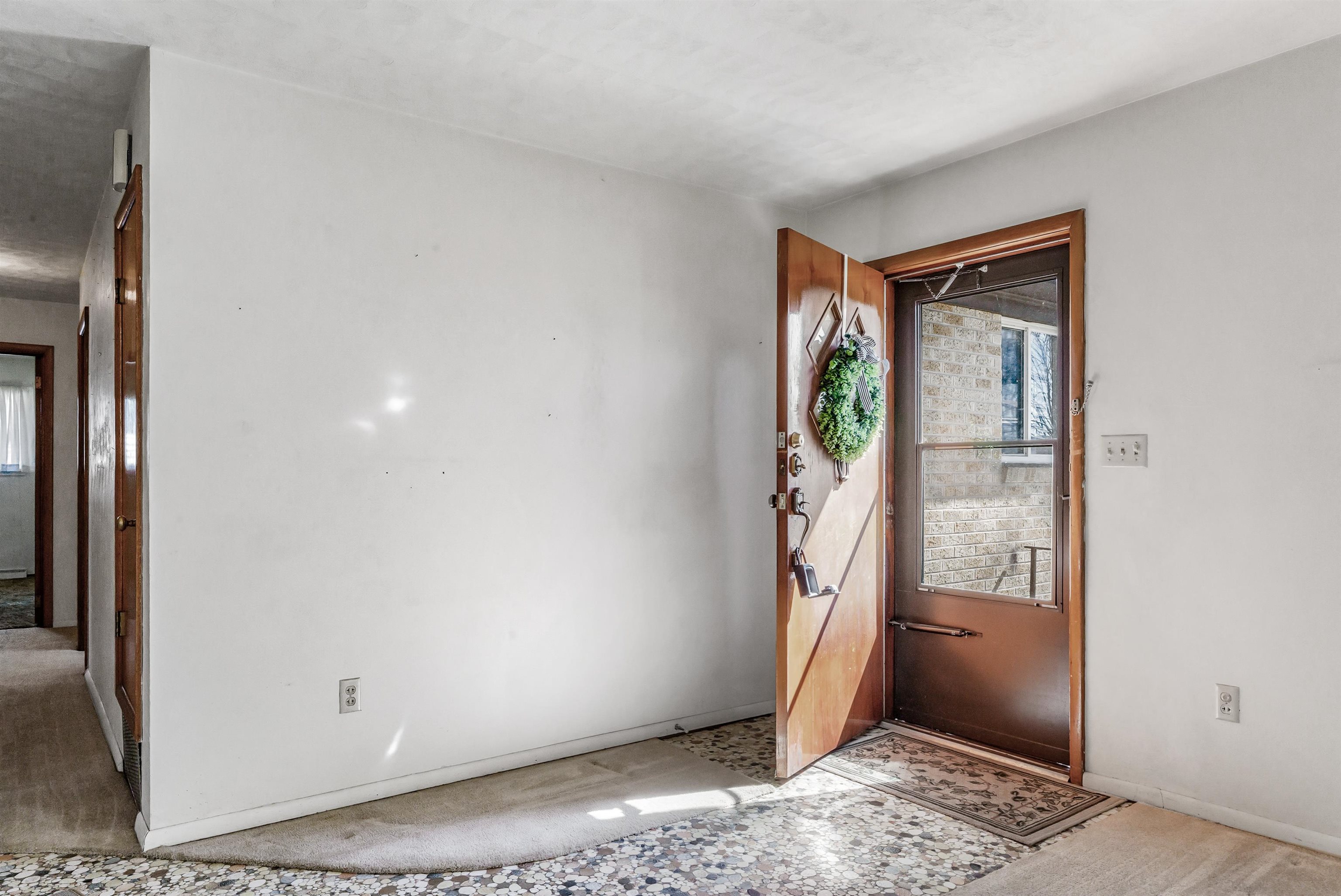Foyer entrance featuring baseboards