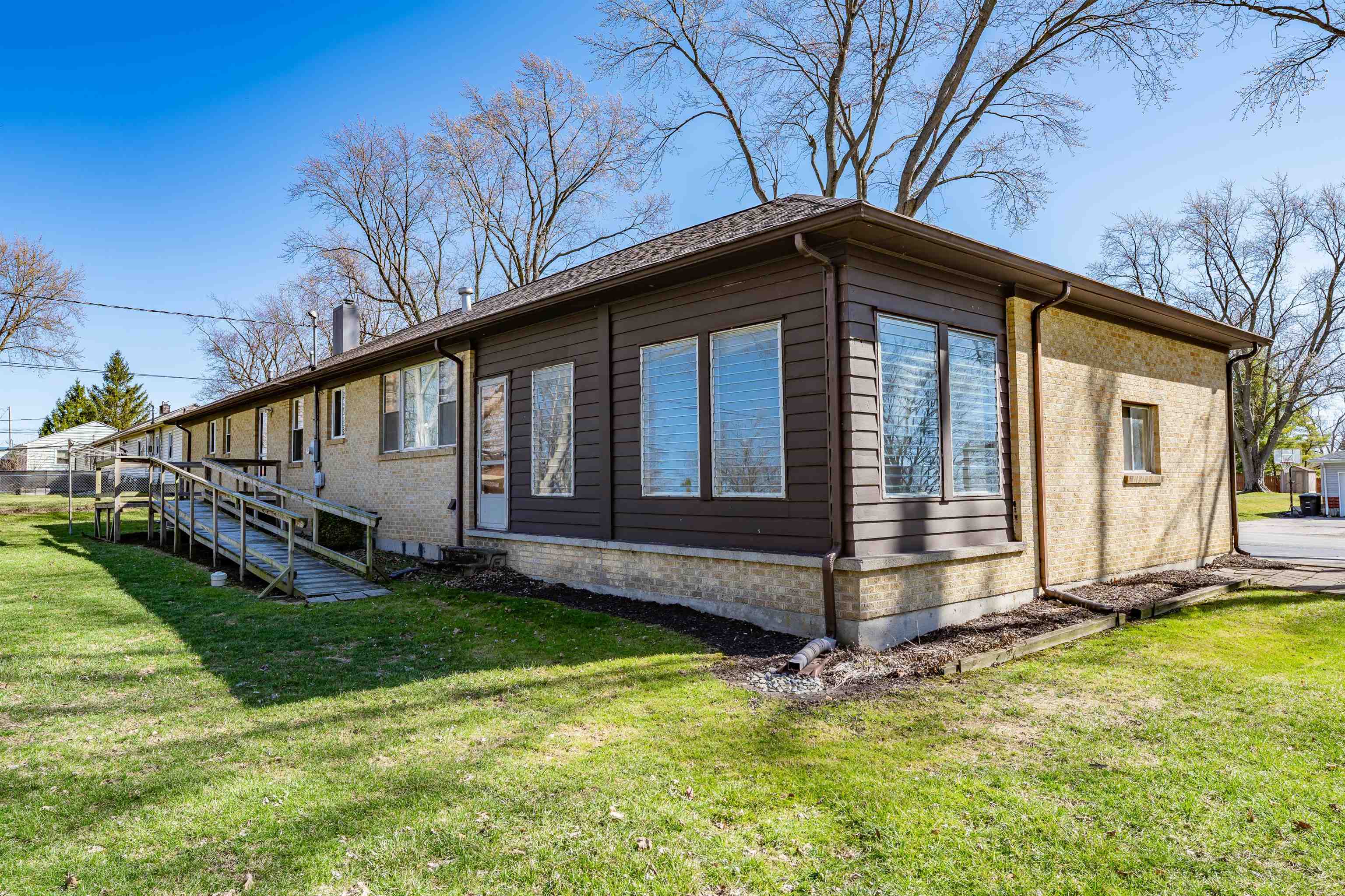View of side of property featuring a yard