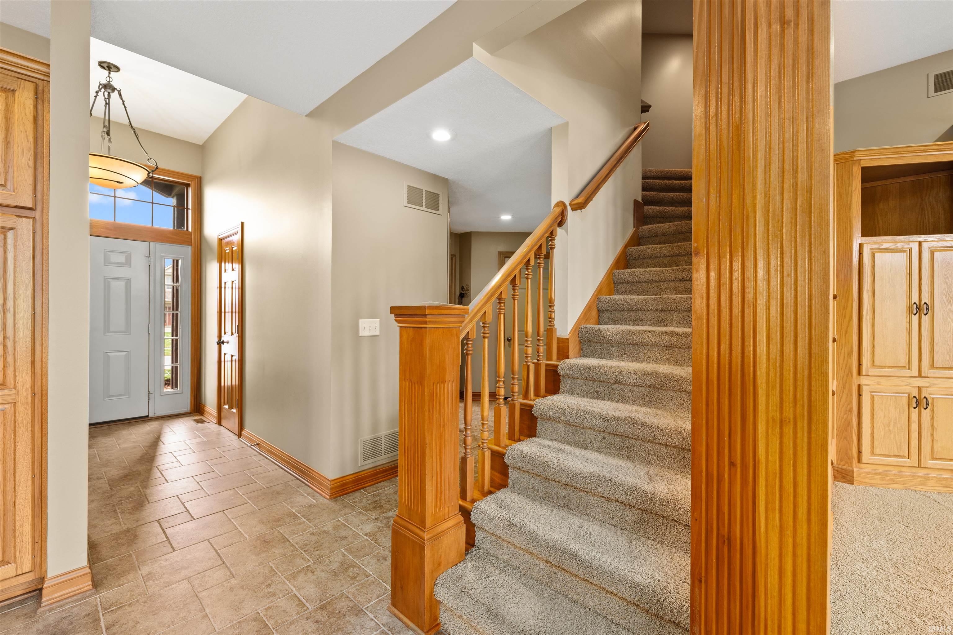 Entrance foyer featuring stairs and recessed lighting