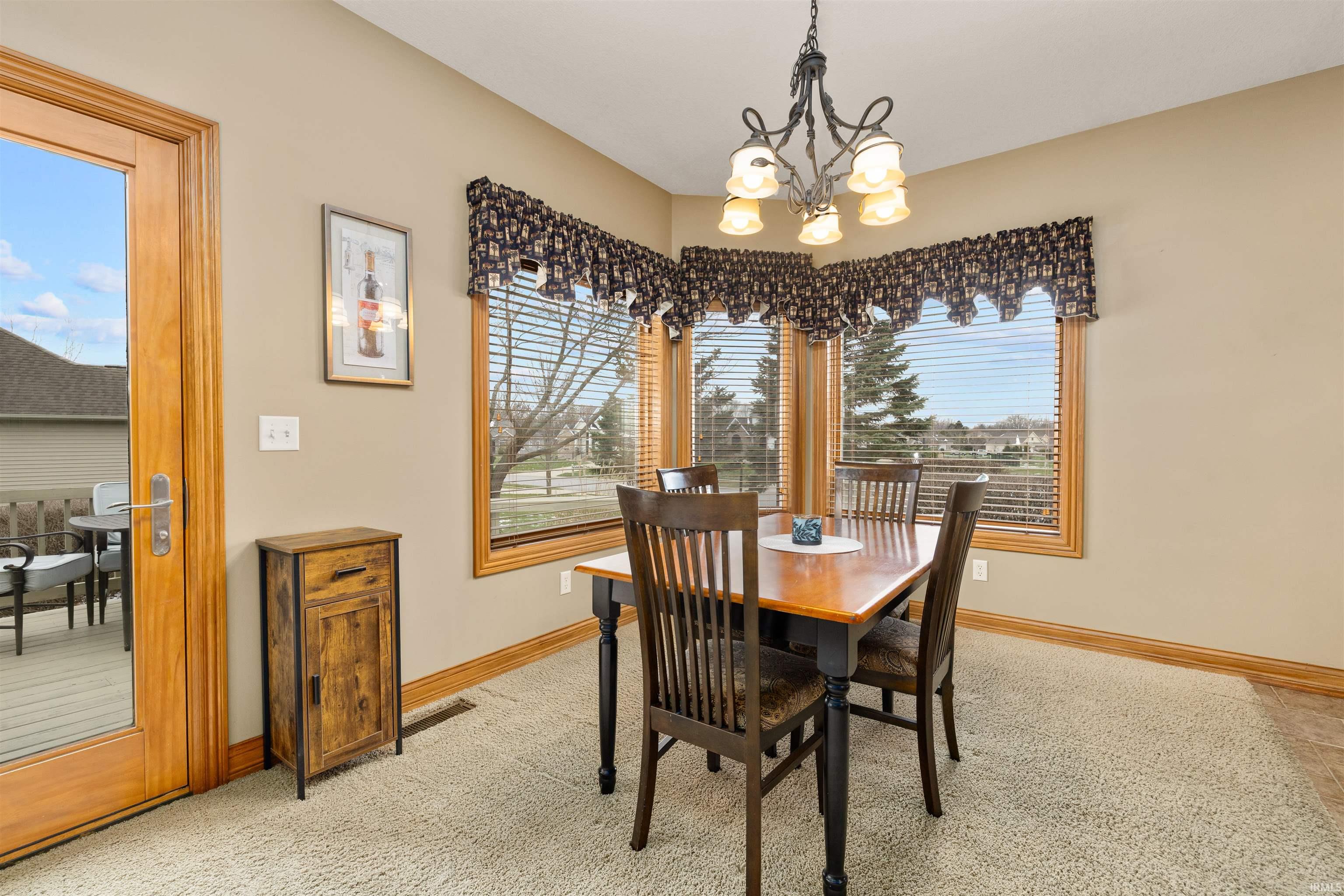 Dining area with suspended lighting and baseboards