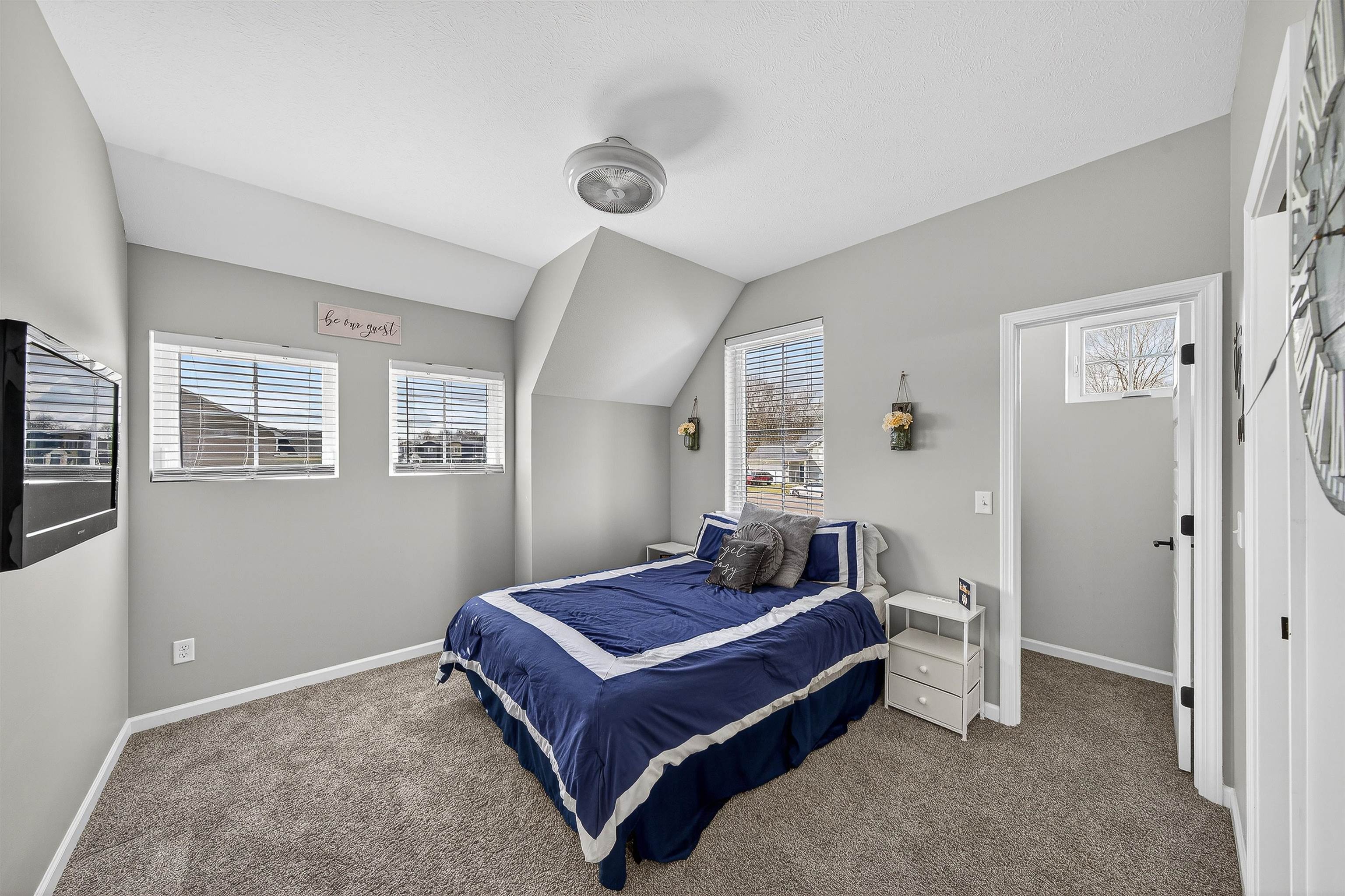Bedroom with vaulted ceiling and carpet