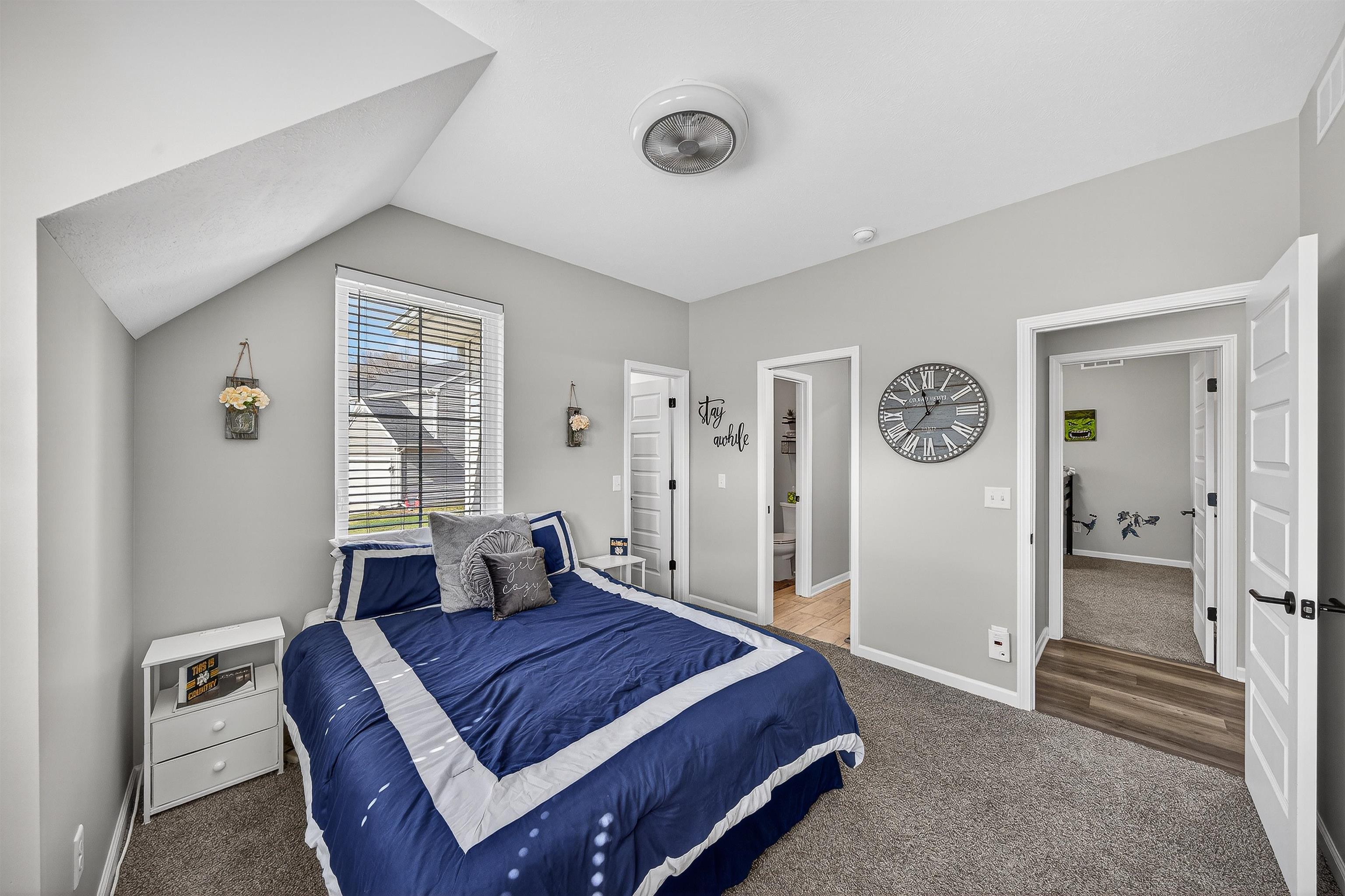 Bedroom with carpet and vaulted ceiling Jack and Jill bath