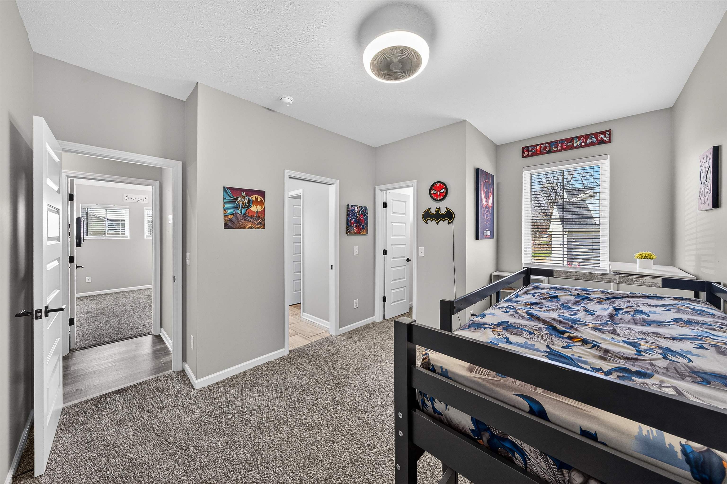 Bedroom with light colored carpet and baseboards