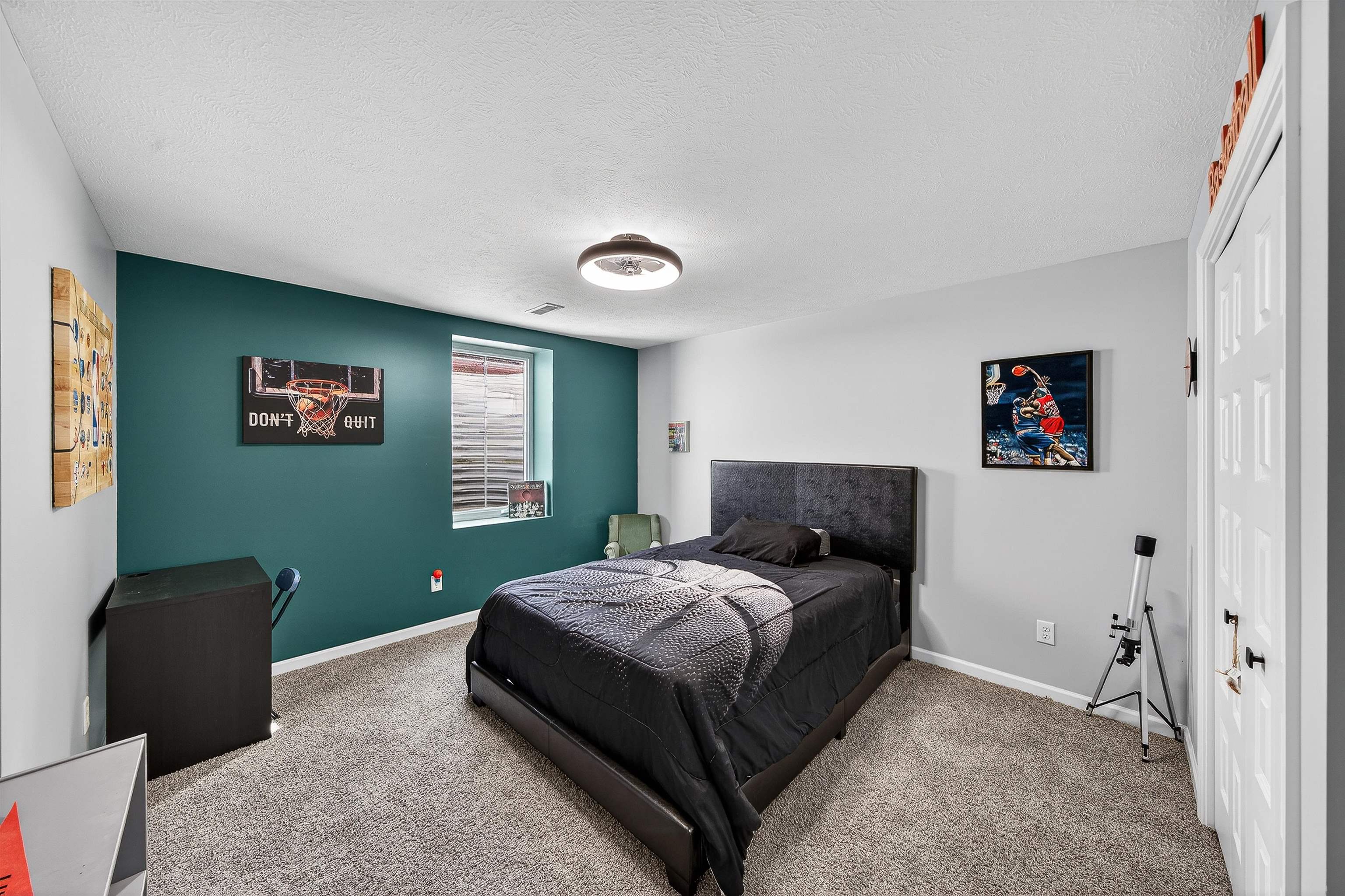 Bedroom featuring carpet floors and a textured ceiling w/egress window